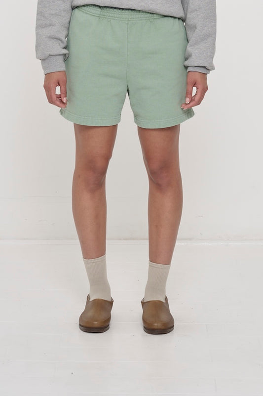 Waist down of a 5'8" person in Size M Wasabi light green Trash Fleece Everyday Shorts. Hem at mid thigh.