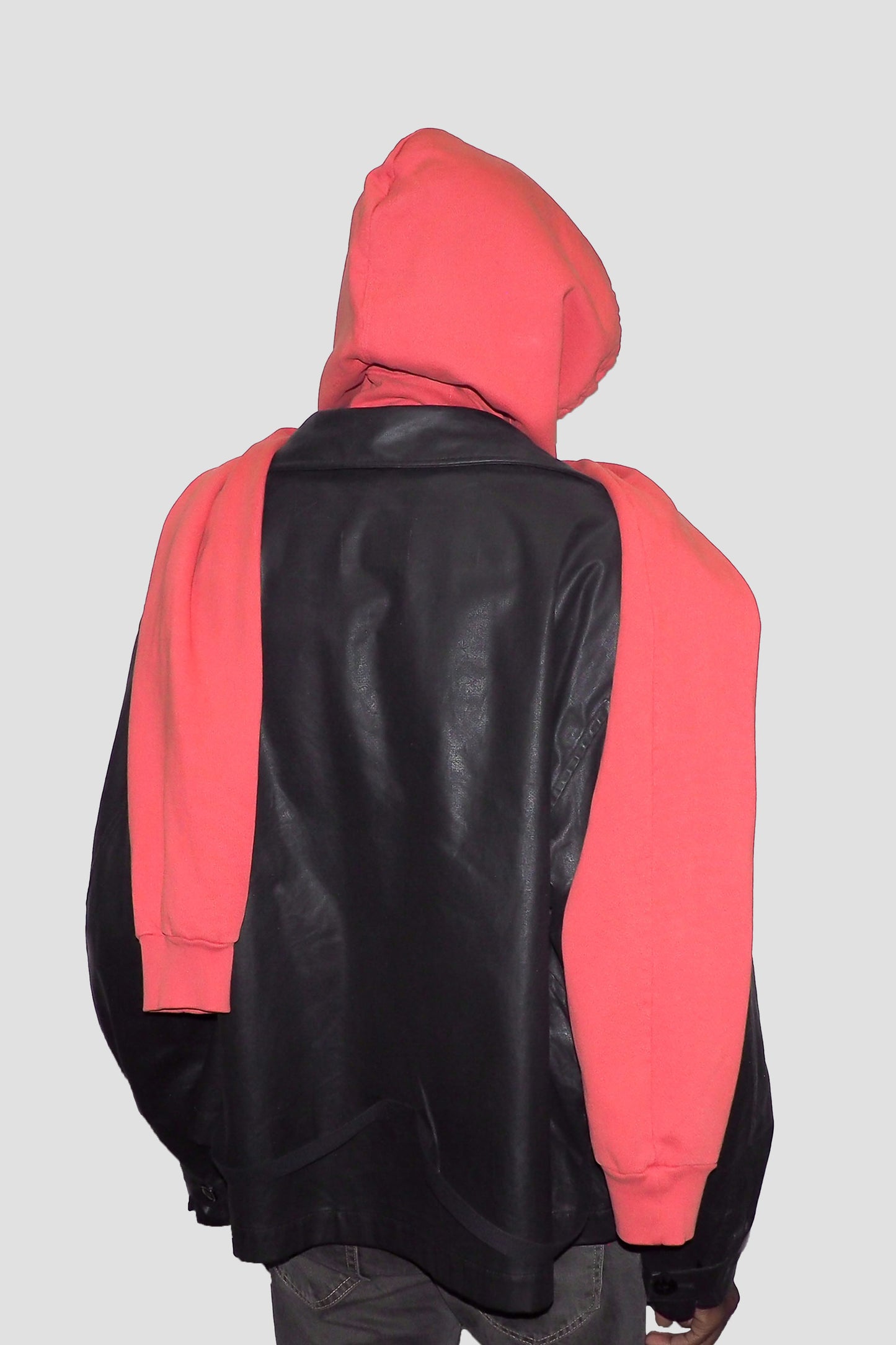 Back view of Cedar Clyde x Everybody.World Hoodie Scarf on model draped over leather jacket.