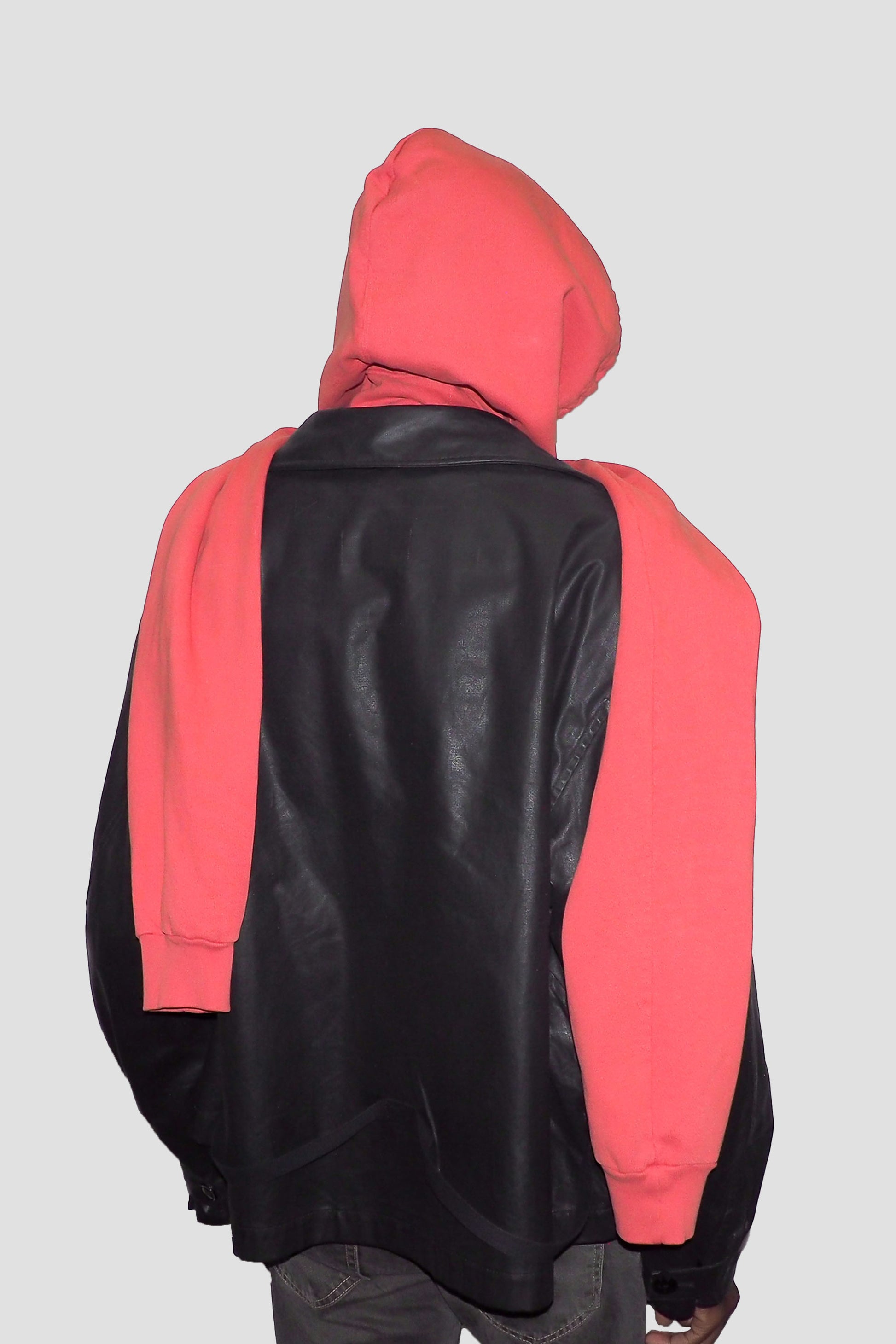Back view of Cedar Clyde x Everybody.World Hoodie Scarf on model draped over leather jacket.