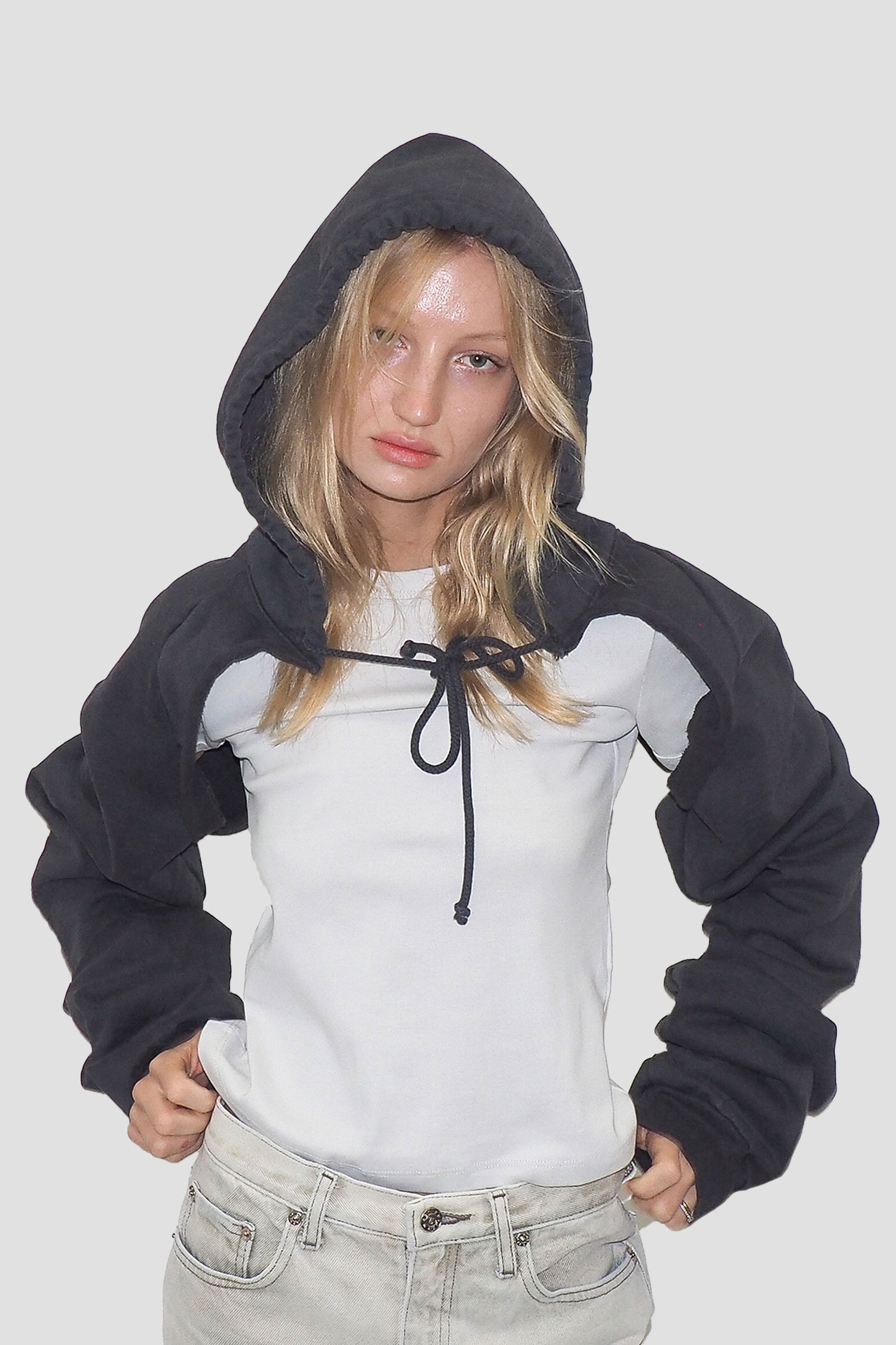 Person wearing a Slate Clyde x Everybody.World Hoodie Scarf over a white T-shirt.