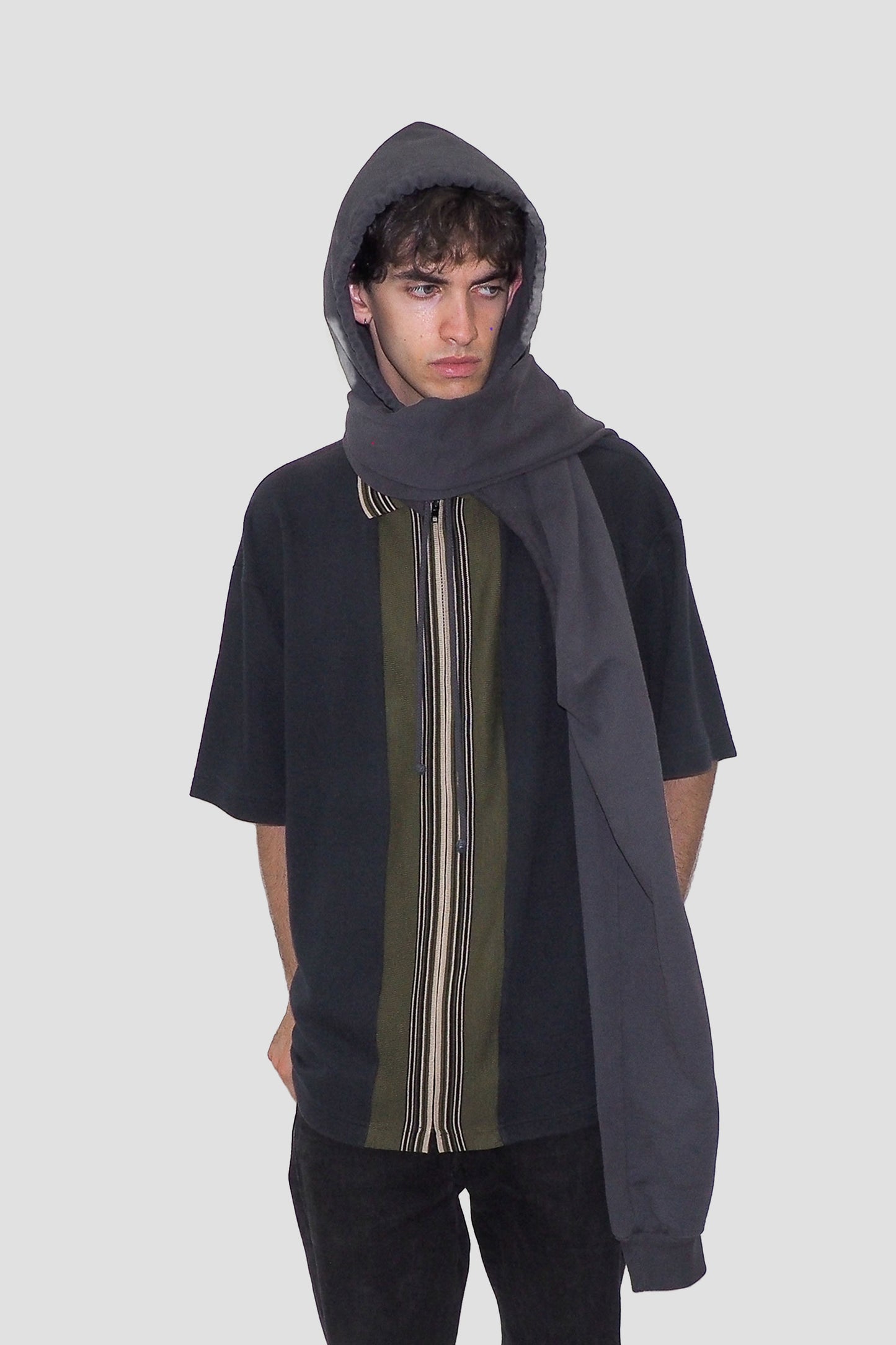 Worn with sleeves crossed over the neck and hood on.