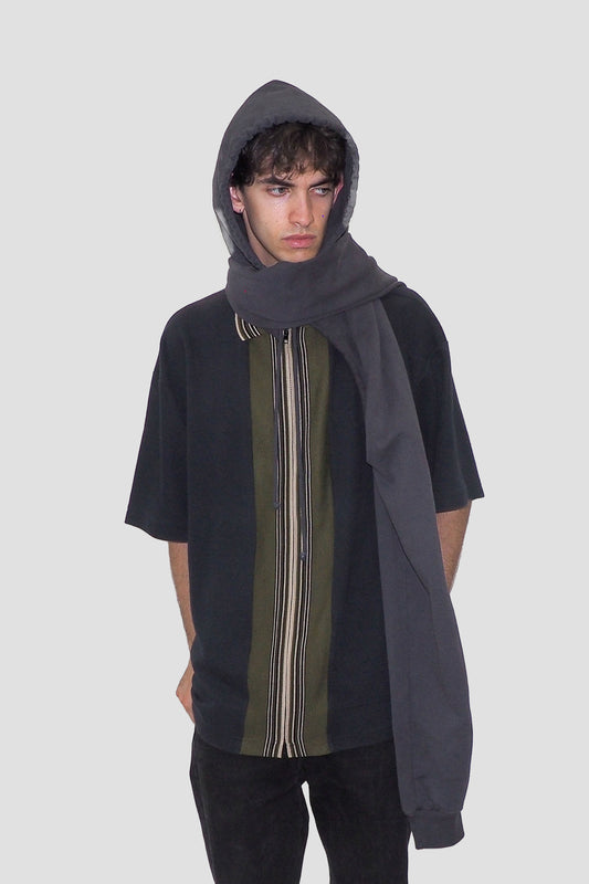 Worn with sleeves crossed over the neck and hood on.