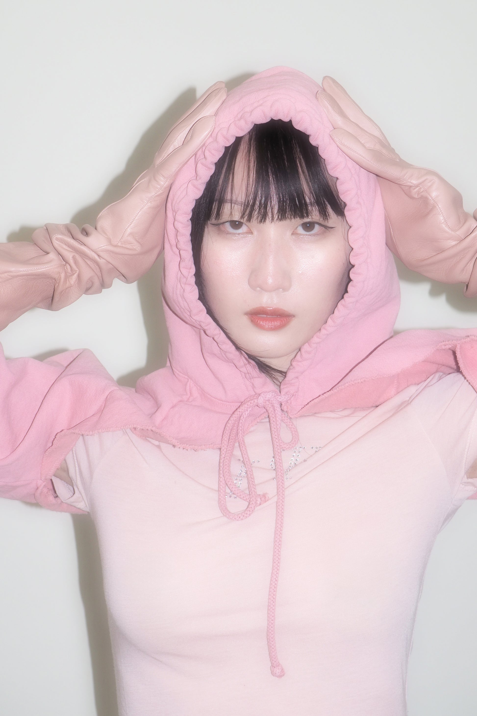 Model with hood on and cinched. Drawcord is tied.