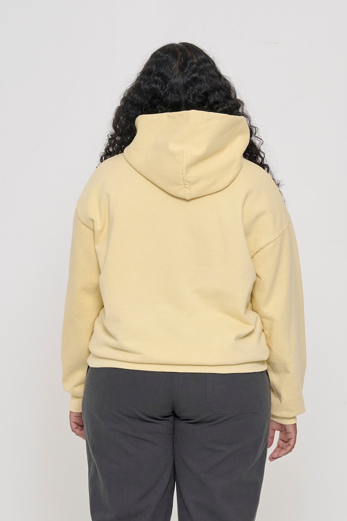 Back view of a woman wearing a French Butter Trash Hoodie, highlighting the hood.