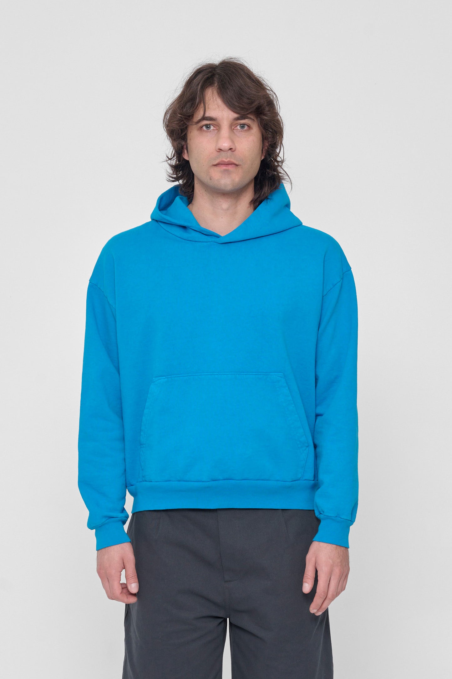 6'2" person in a size M Malibu Trash Hoodie. Hem rest at their middle hip.
