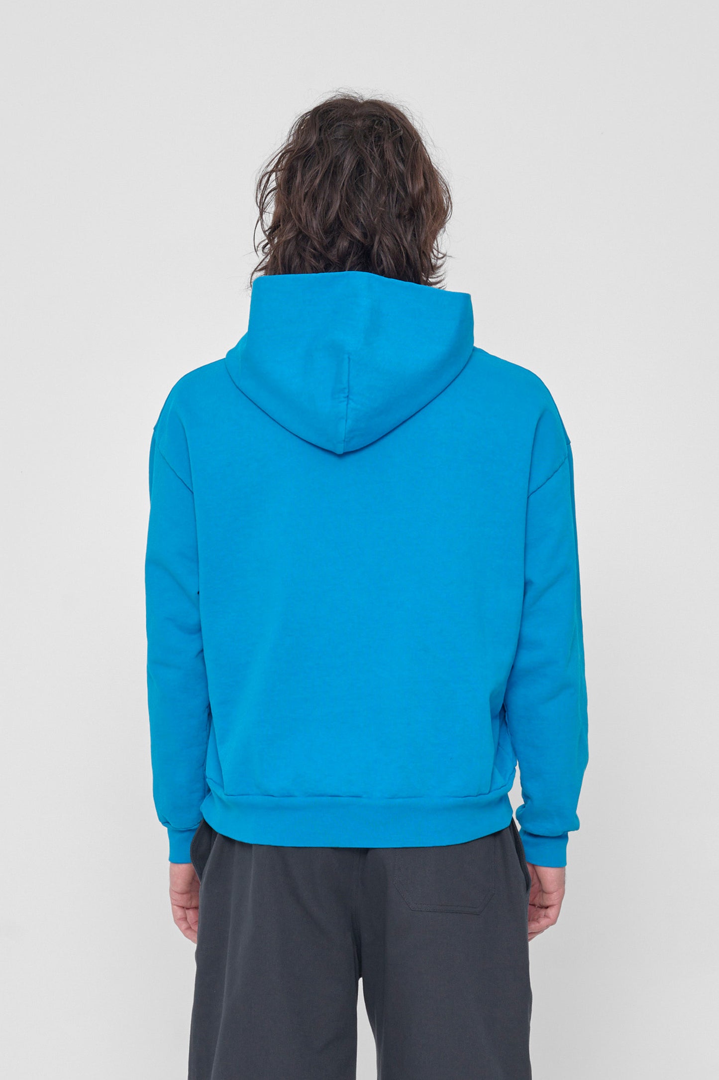 Back view of a man highlighting the hood.