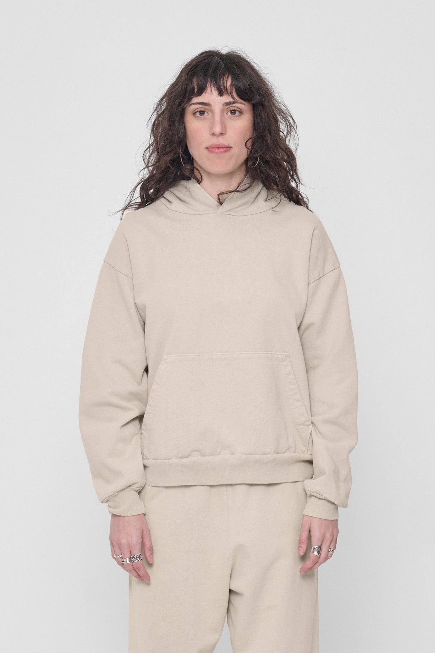 5'6" woman in a size S Oat Trash Hoodie. Hem rests at her lower-middle hip.