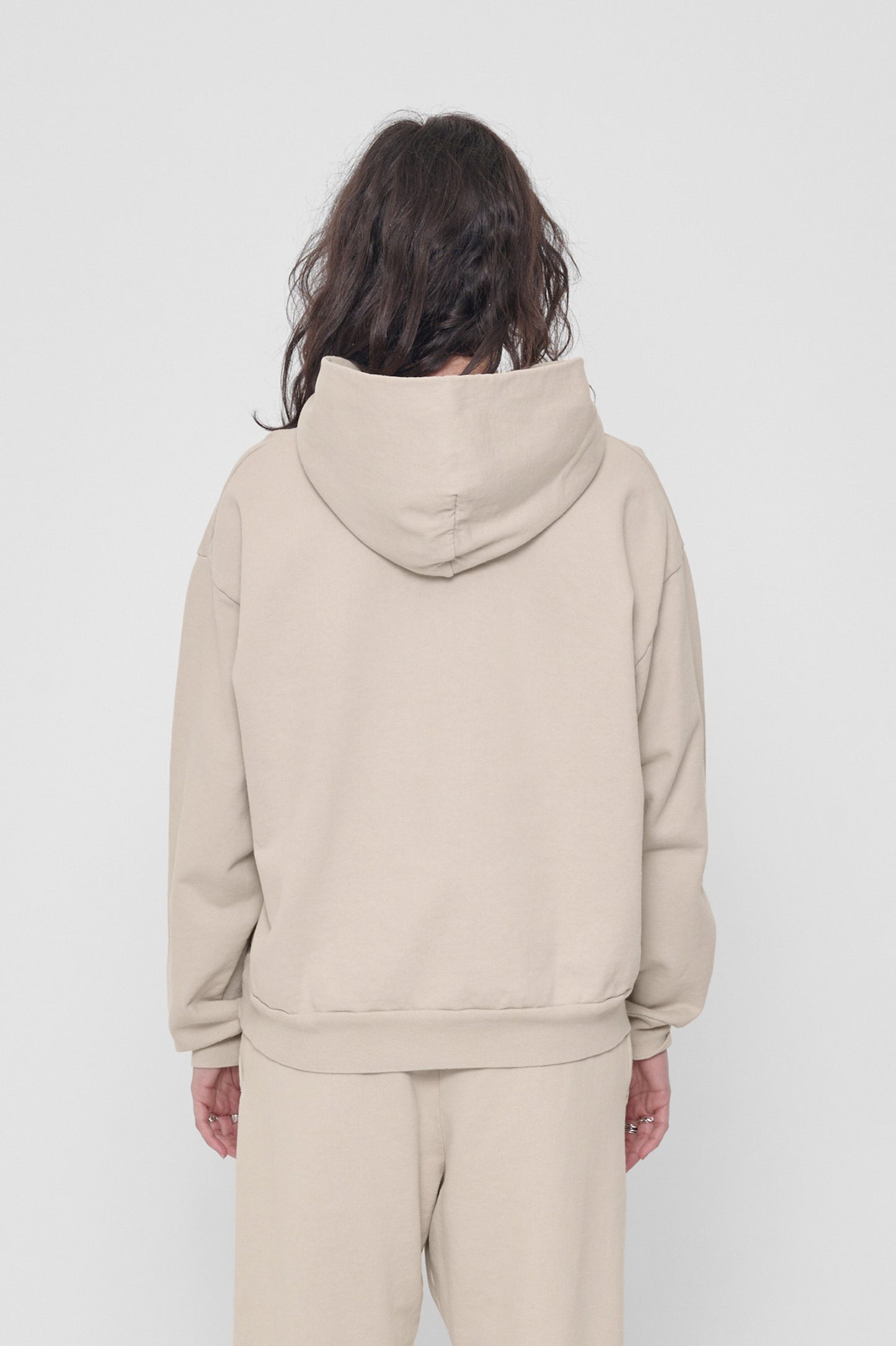 Back view of a woman highlighting the hood.