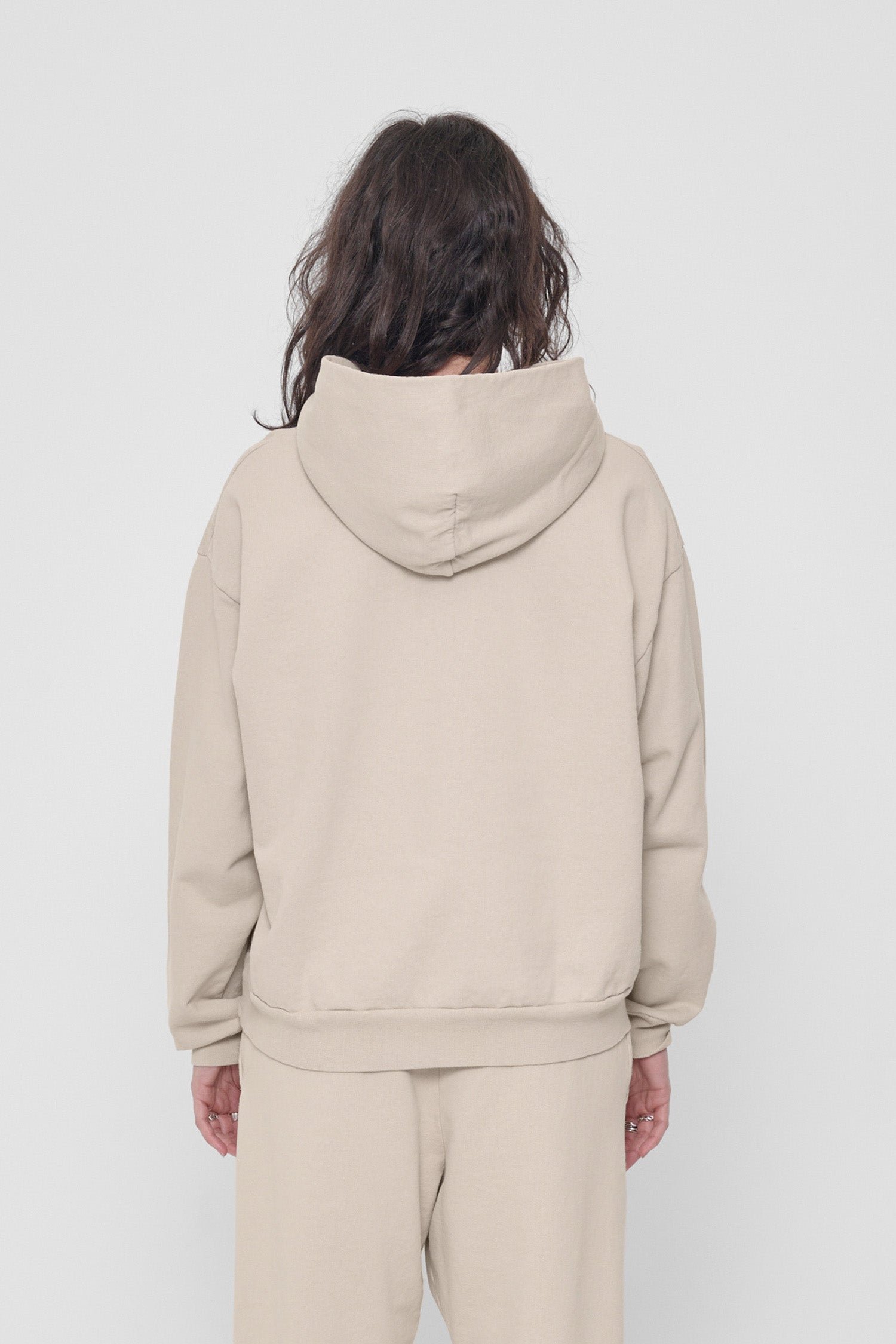 Back view of a woman highlighting the hood.