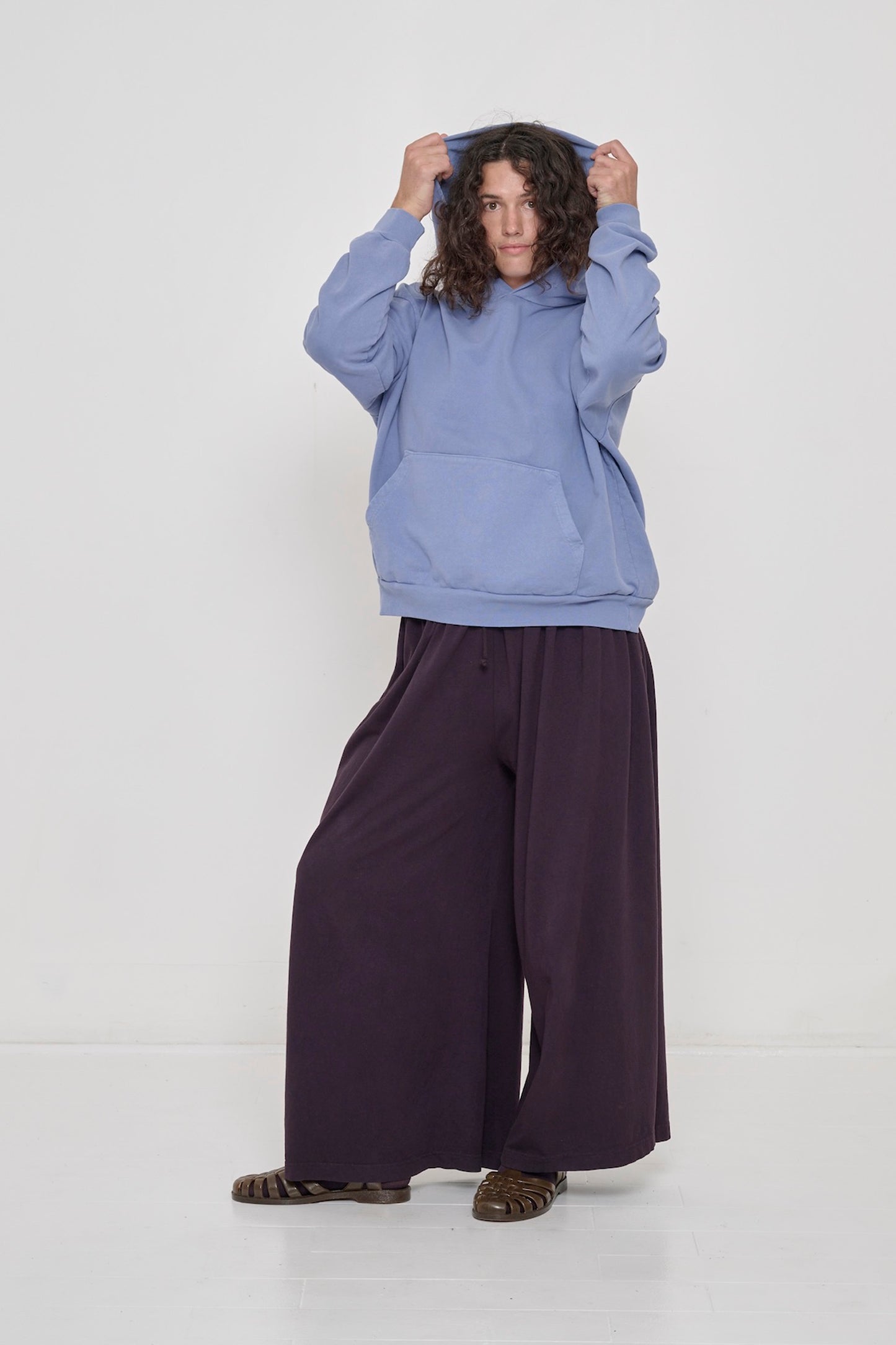Person wearing a Periwinkle Trash Hoodie with Mulberry Tubular Pants.