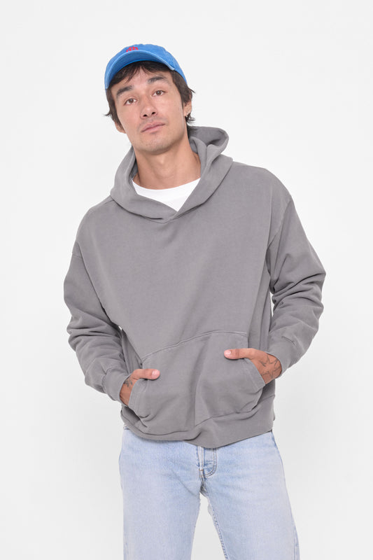 Trash Hoodie in Stone – front view, model's hands in kangaroo pockets