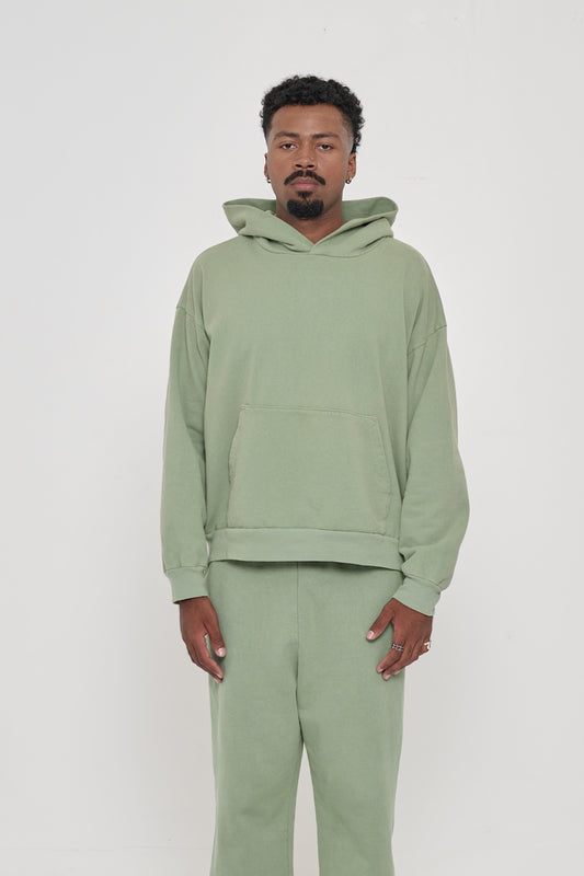 Front view of a man wearing a Wasabi Trash Hoodie. Hem hits his hip.