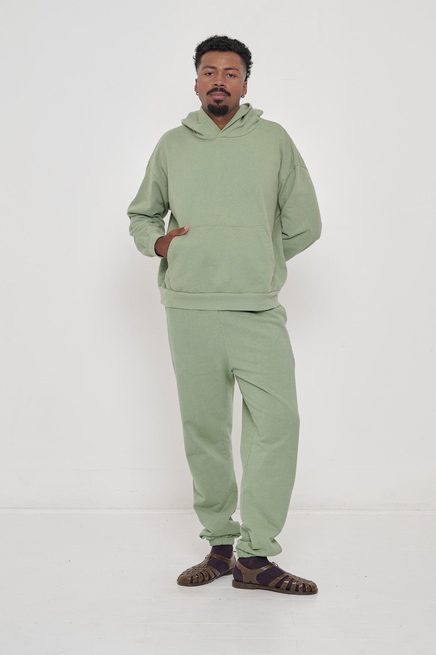 Man wearing a Wasabi Trash Hoodie with Wasabi Trash Sweatpants.