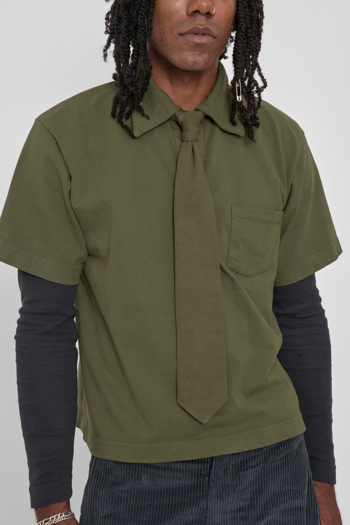 Trash Polo in Olive - close up front view on model
