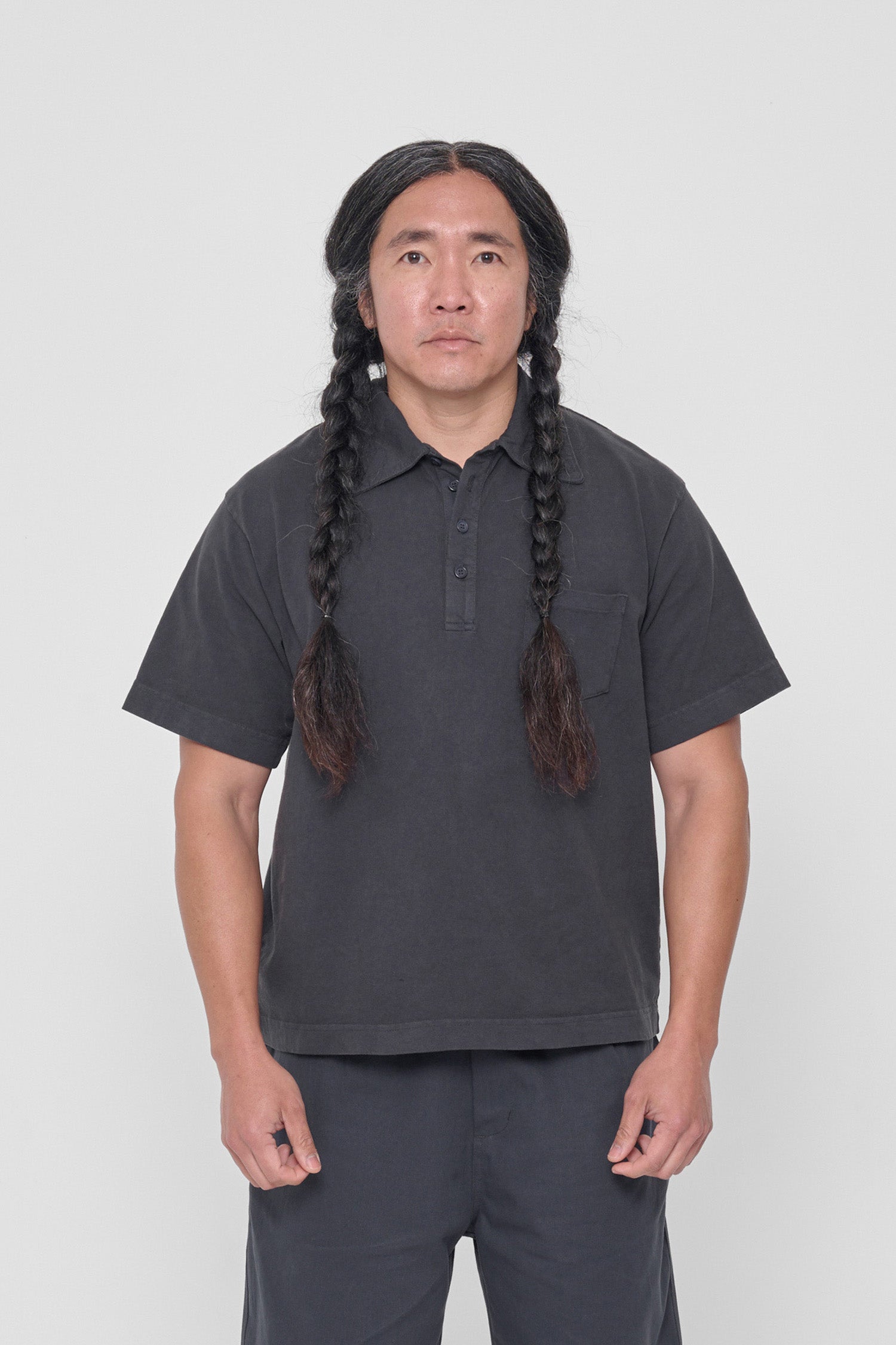 A 5'11" man in a size L Slate Trash Polo. Hem ends at his middle hip.