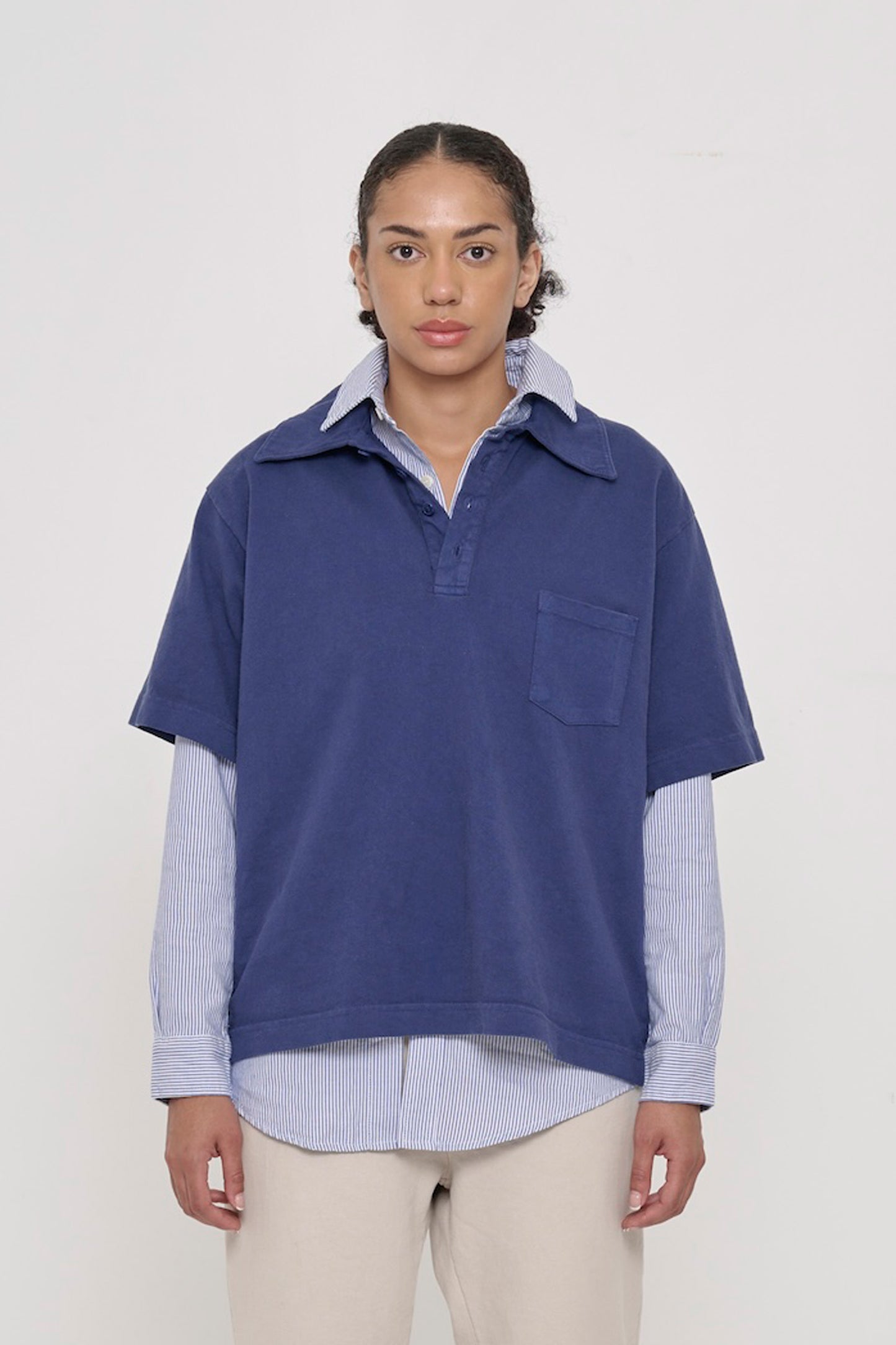 Front view of a 5'8" woman wearing a Trash Polo in Washed Navy over a Stripe Poplin Button-Up Shirt. Hem hits lower-mid hip.