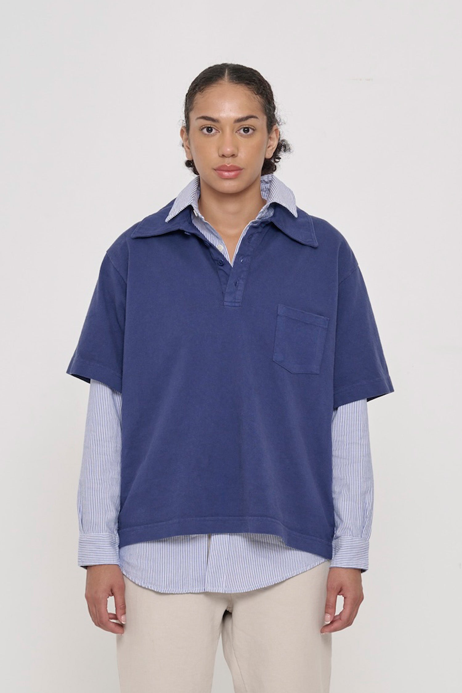 Front view of a 5'8" woman wearing a Trash Polo in Washed Navy over a Stripe Poplin Button-Up Shirt. Hem hits lower-mid hip.