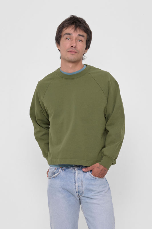 Trash Raglan in Olive – front view on model