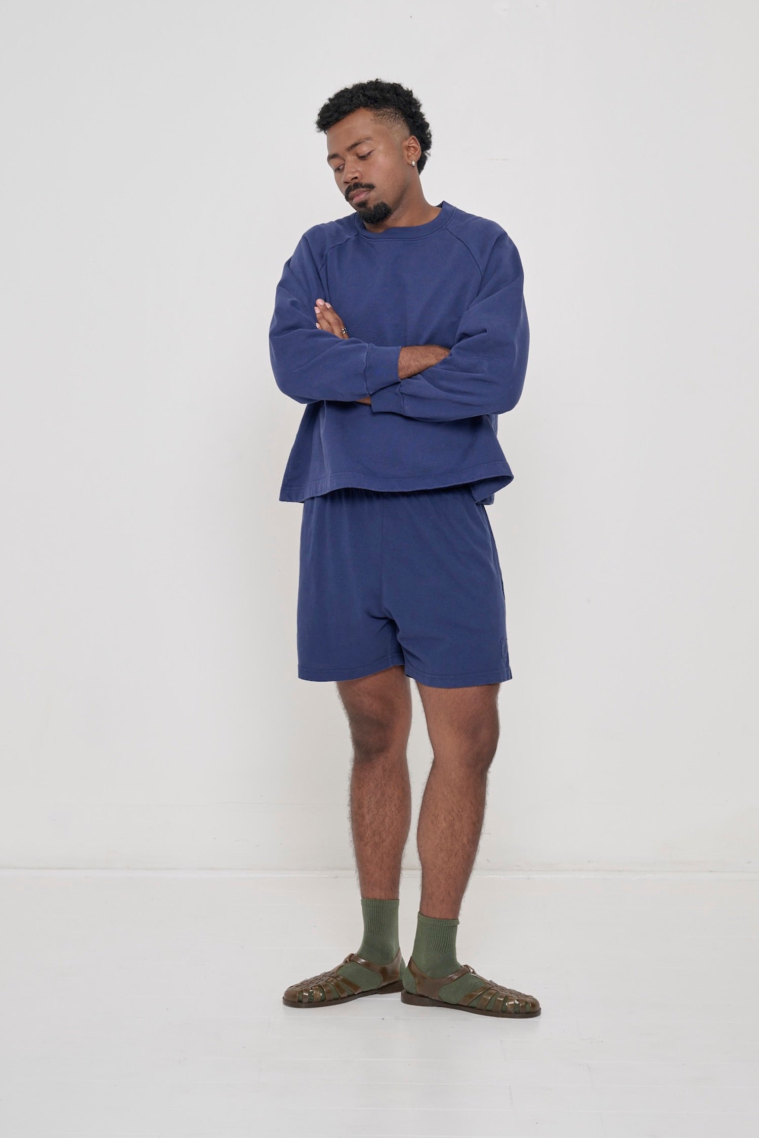 Front full length: man in a Washed Navy Trash Raglan and matching Everyday Shorts showcasing boxy fit.