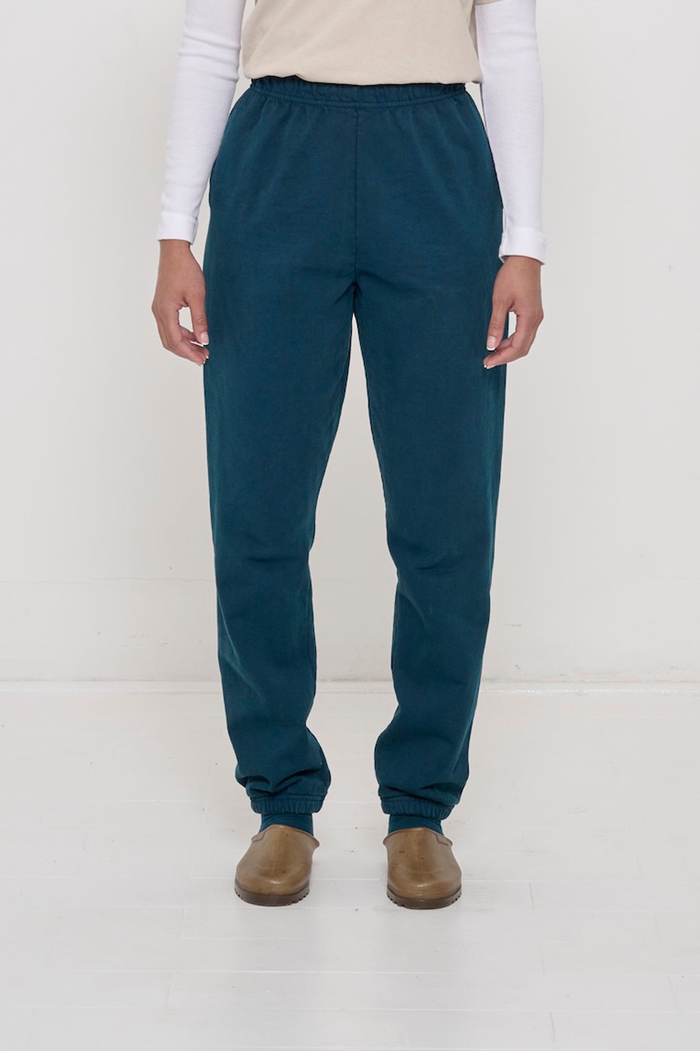 Front view of a person in Juniper Trash Sweatpants, relaxed fit, mild slouchy bunching at ankles.
