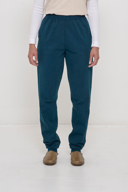 Front view of a person in Juniper Trash Sweatpants, relaxed fit, mild slouchy bunching at ankles.