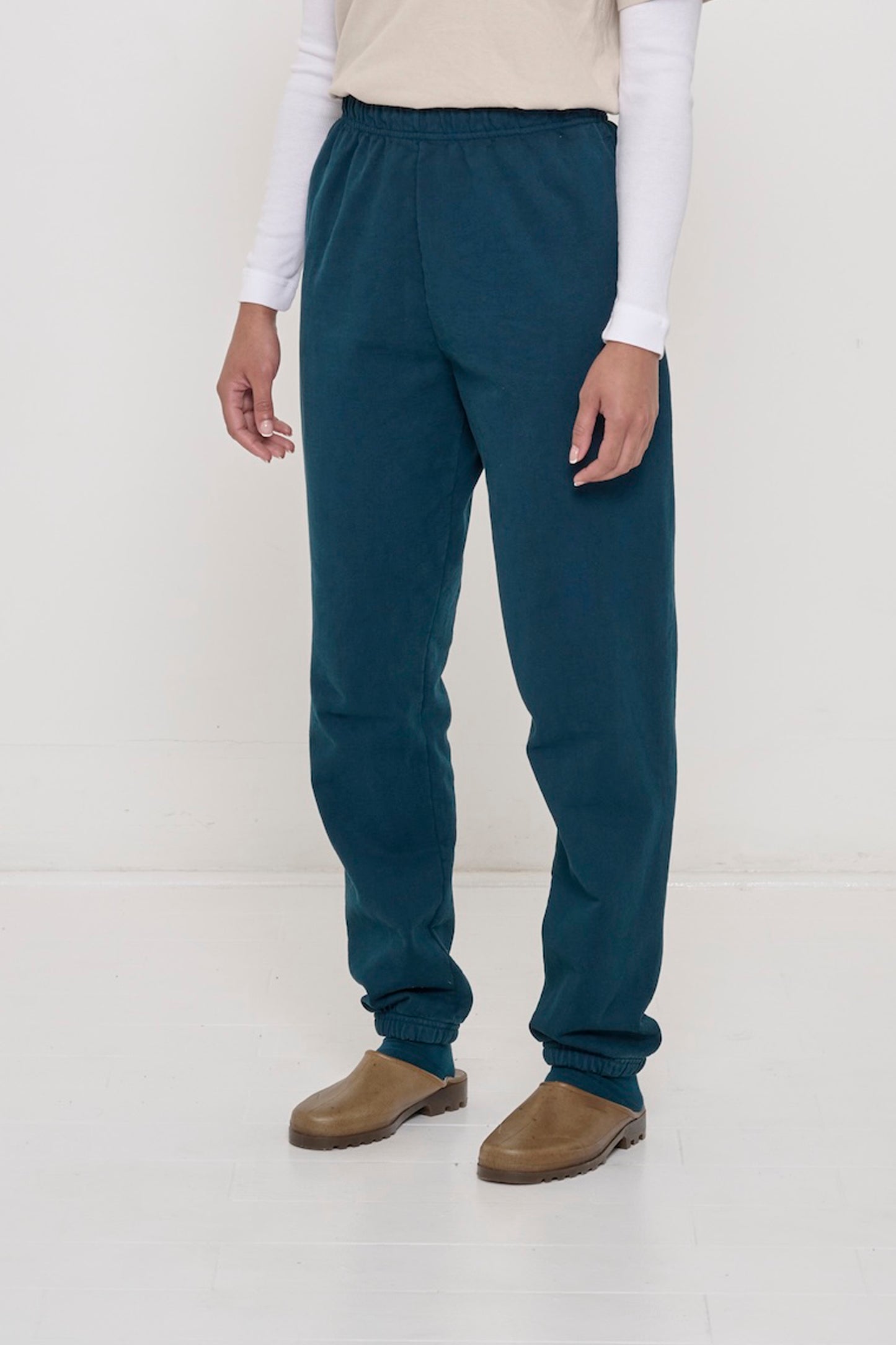 Person turned 45 degrees, wearing Juniper Trash Sweatpants, showing inseam and top of the side pockets.