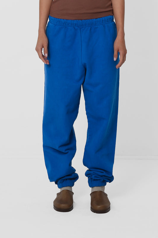 A 5'5" woman in size S Lapis Trash Sweatpants. Relaxed fit throughout, and bunching at the ankles.