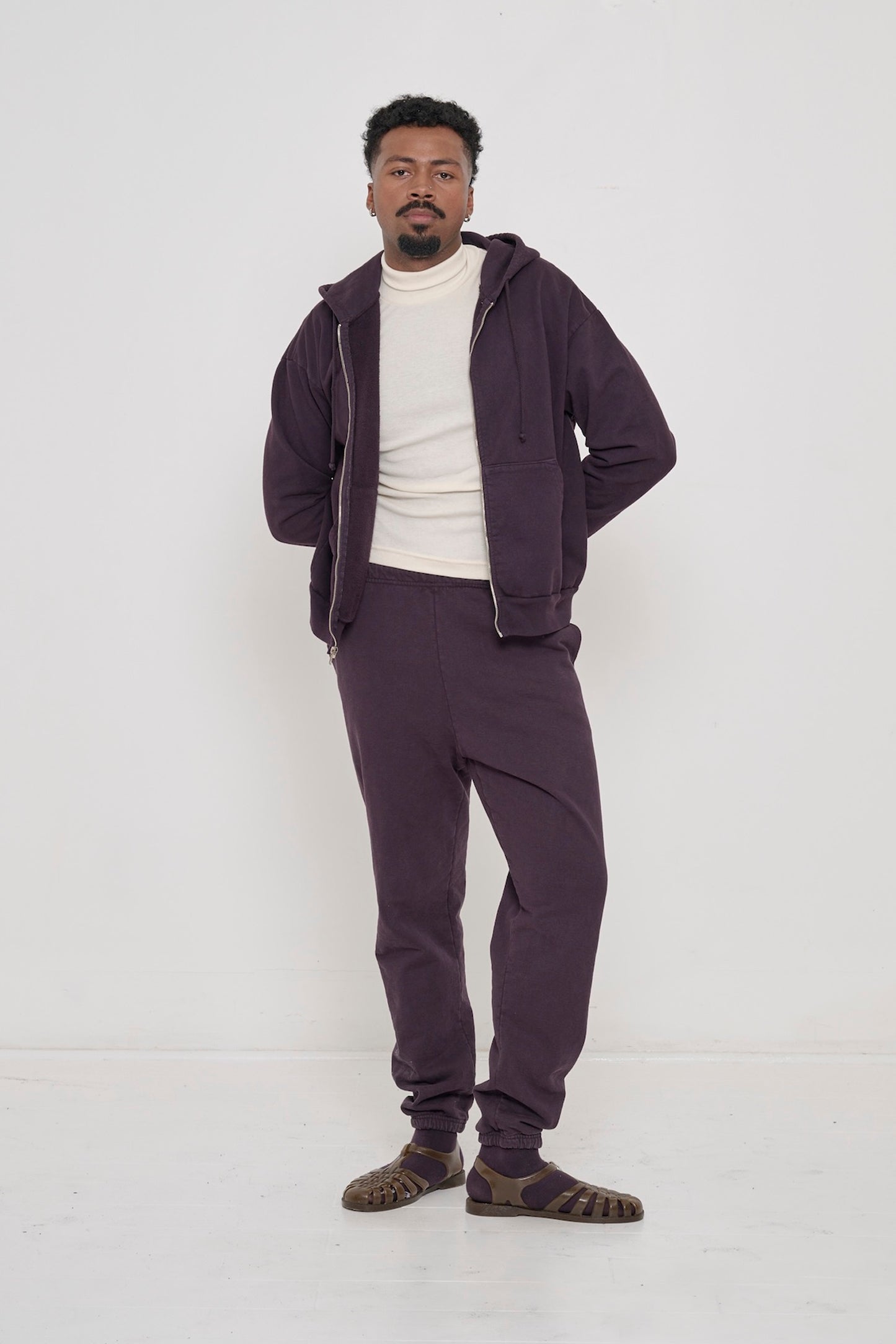 Person wearing Mulberry Trash Zip Up with hands in pockets and Mulberry Trash Sweatpants.