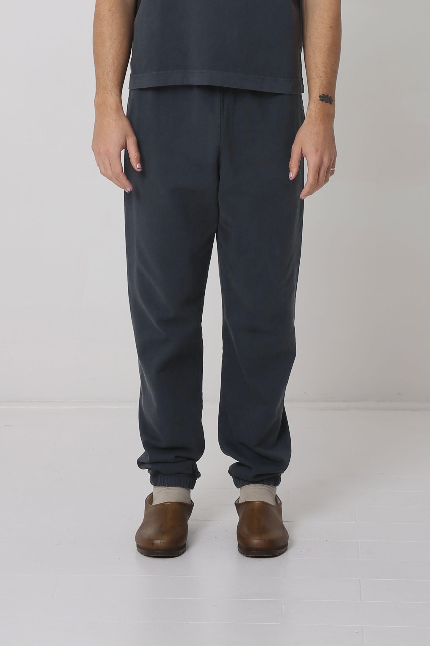 A 6' person in size M Slate Trash Sweatpants. Slight bunching at the ankles.