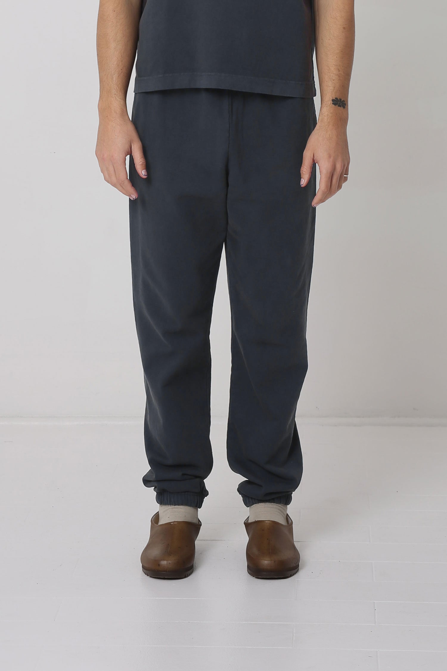 A 6' person in size M Slate Trash Sweatpants. Slight bunching at the ankles.