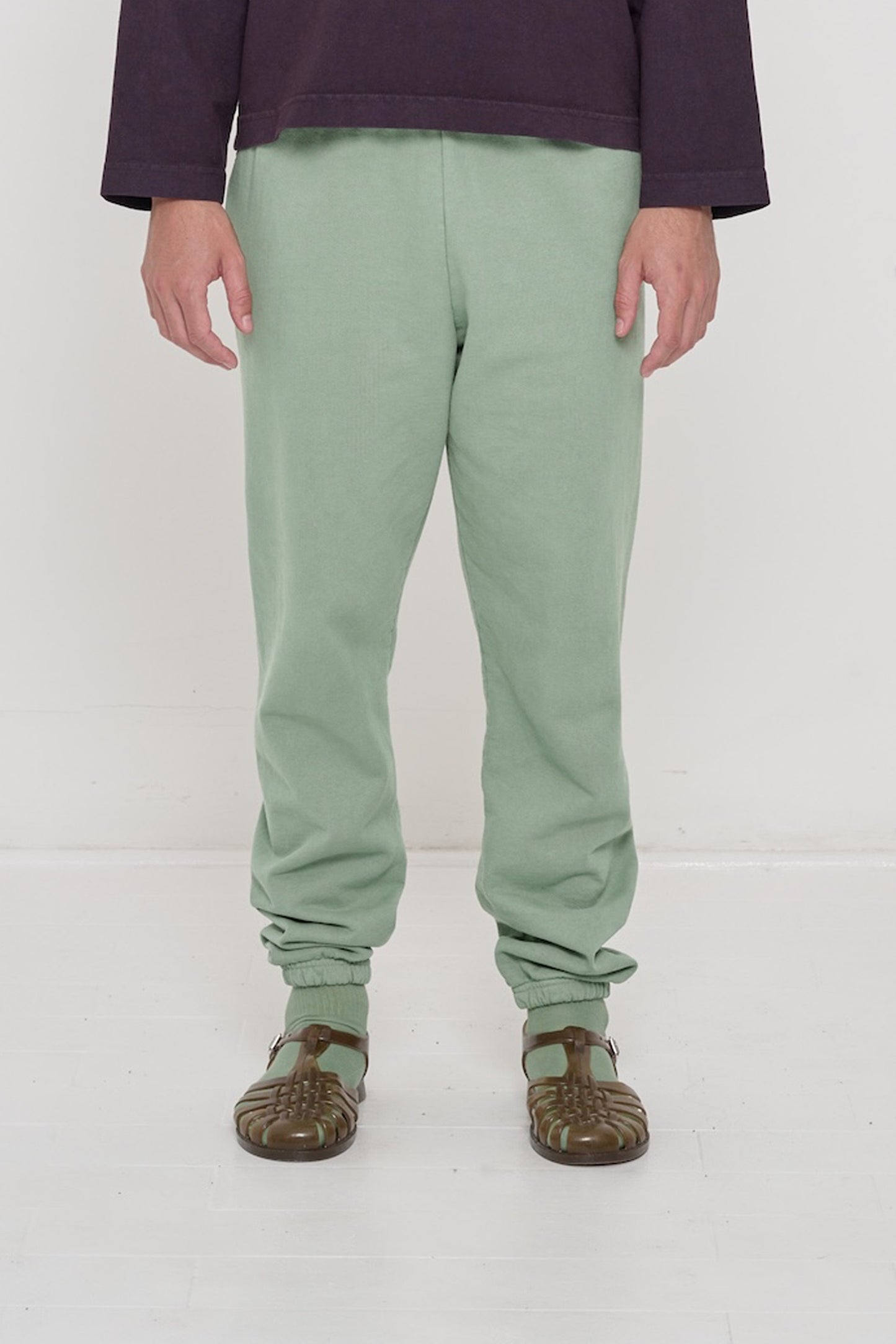 Front view of a person in Wasabi Trash Sweatpants, relaxed fit, mild slouchy bunching at ankles.