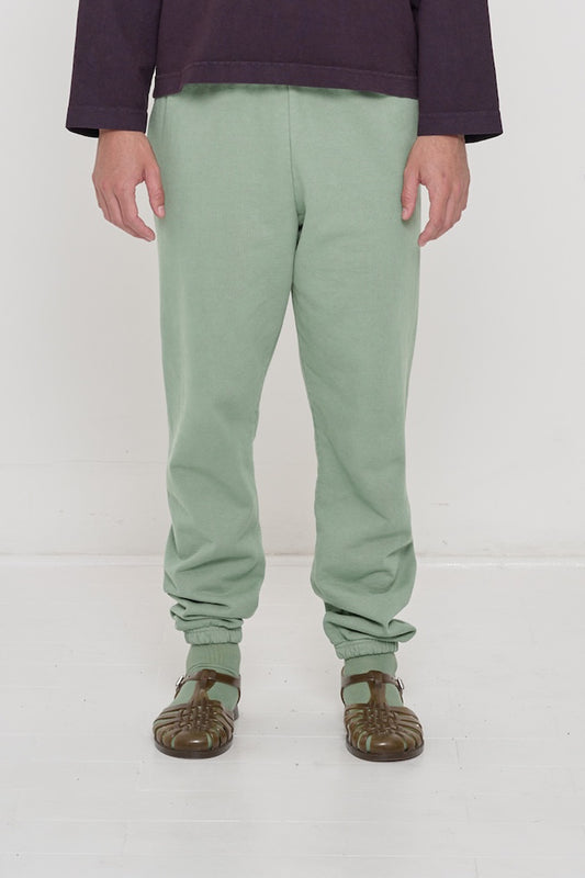 Front view of a person in Wasabi Trash Sweatpants, relaxed fit, mild slouchy bunching at ankles.