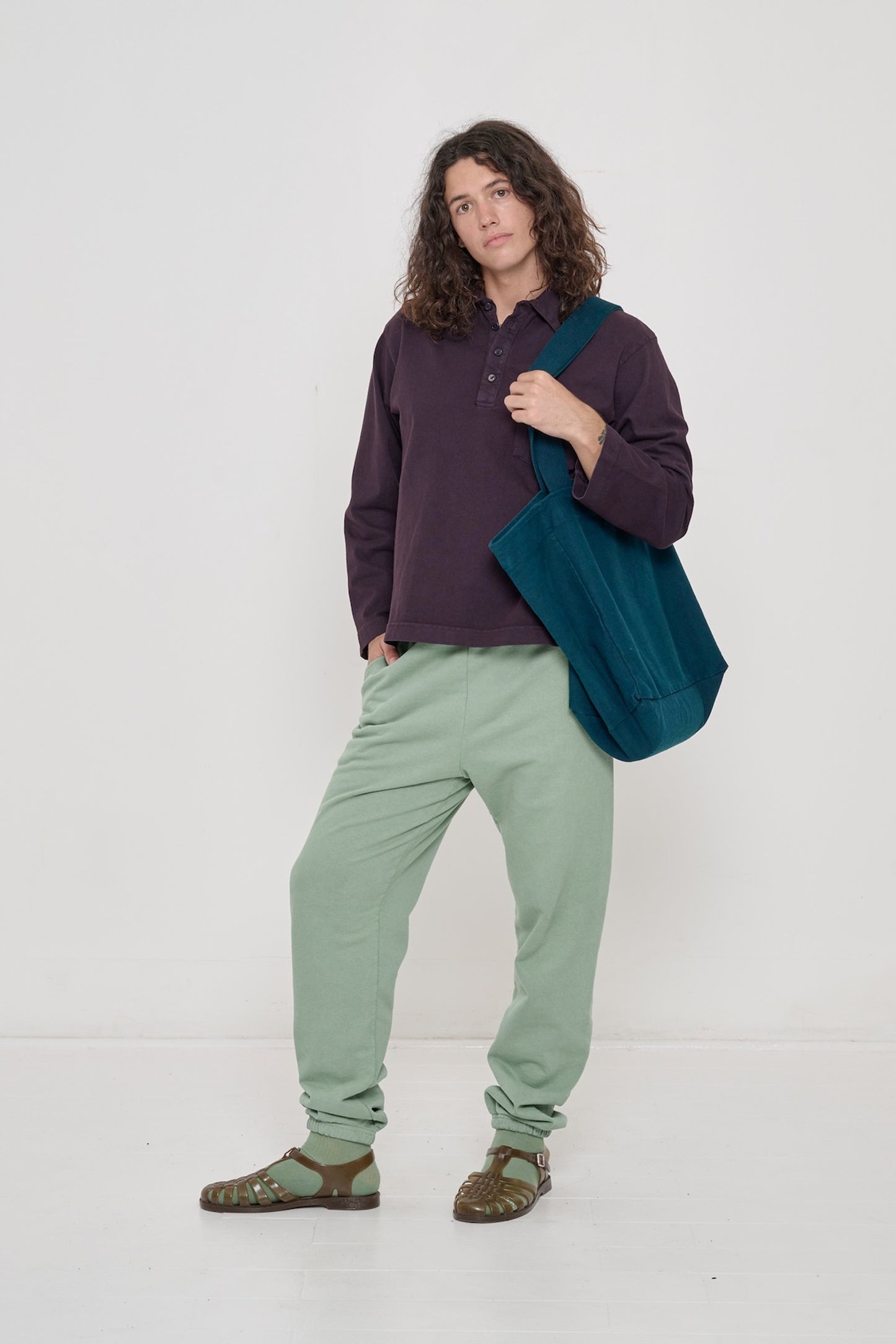 Person wearing Mulberry Rugby Trash Polo with one hand in pocket of Wasabi Trash Sweatpants.