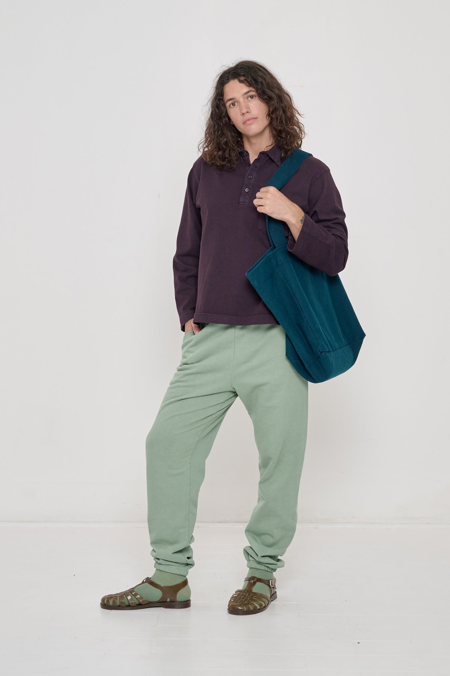 Person wearing Mulberry Rugby Trash Polo with one hand in pocket of Wasabi Trash Sweatpants.