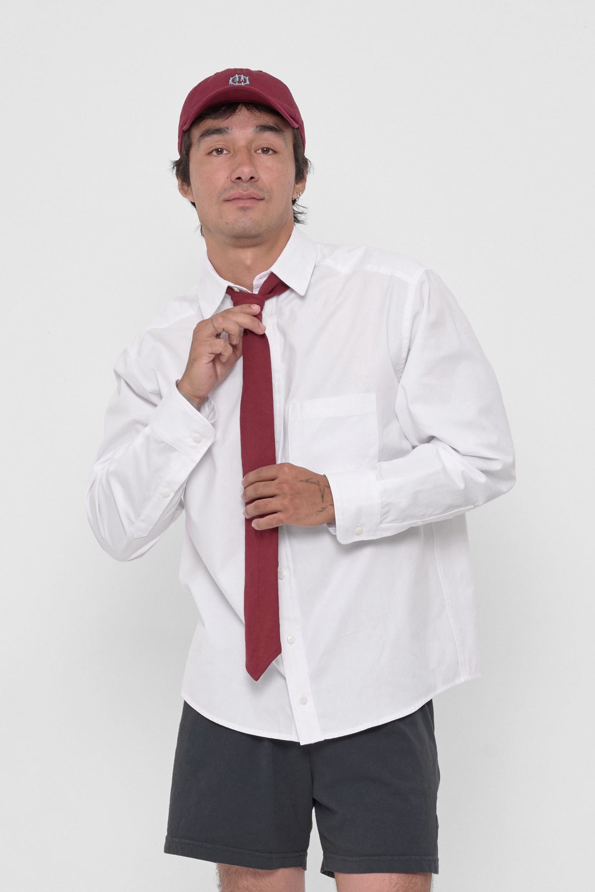 Trash Tie in Garnet – on a model, tied around the collar of a White Peach Fuzz Button-Up Shirt