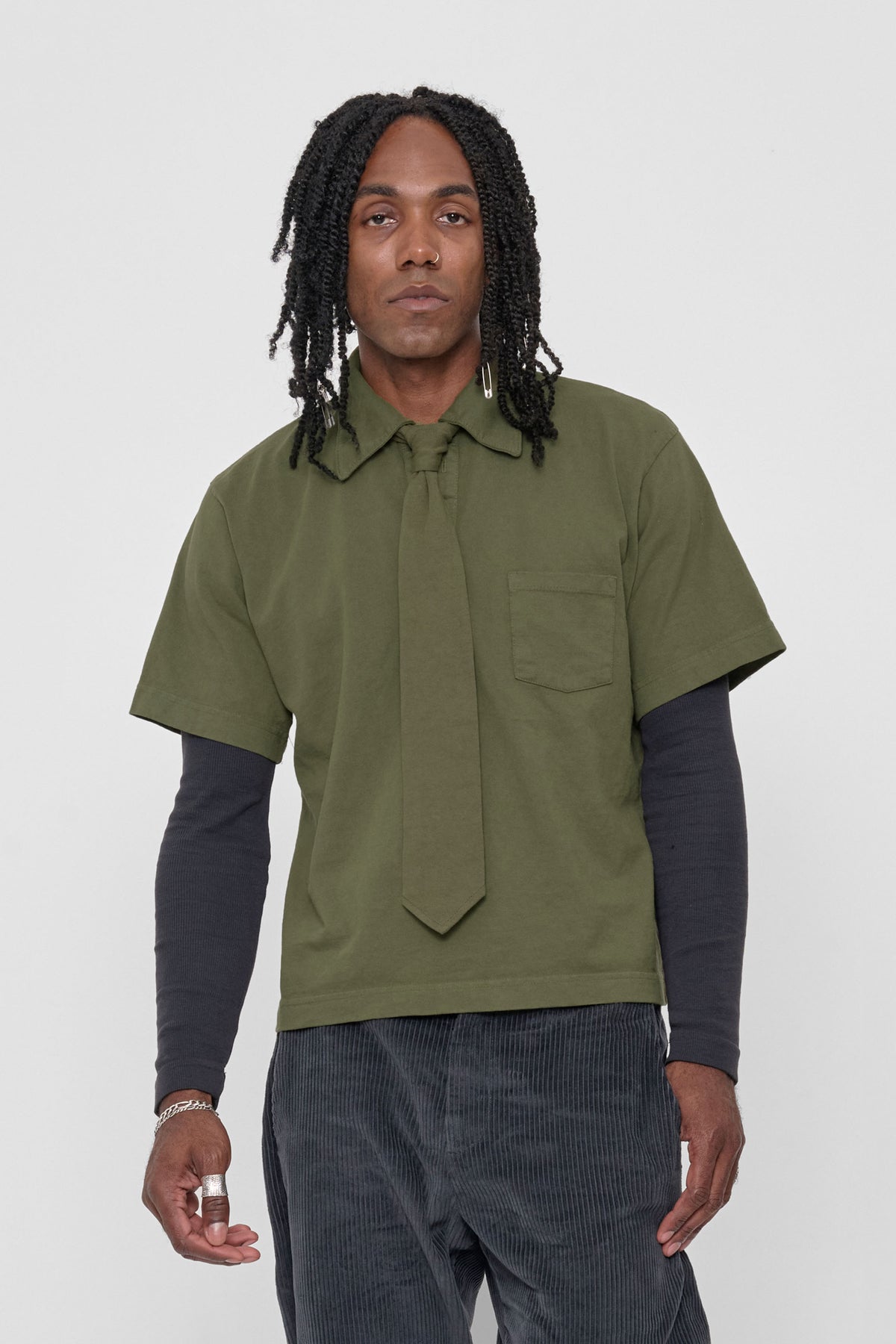 Trash Tie in Olive – on a model, tied around the collar of a matching Trash Polo, layered over a Slate Rib Long Sleeve