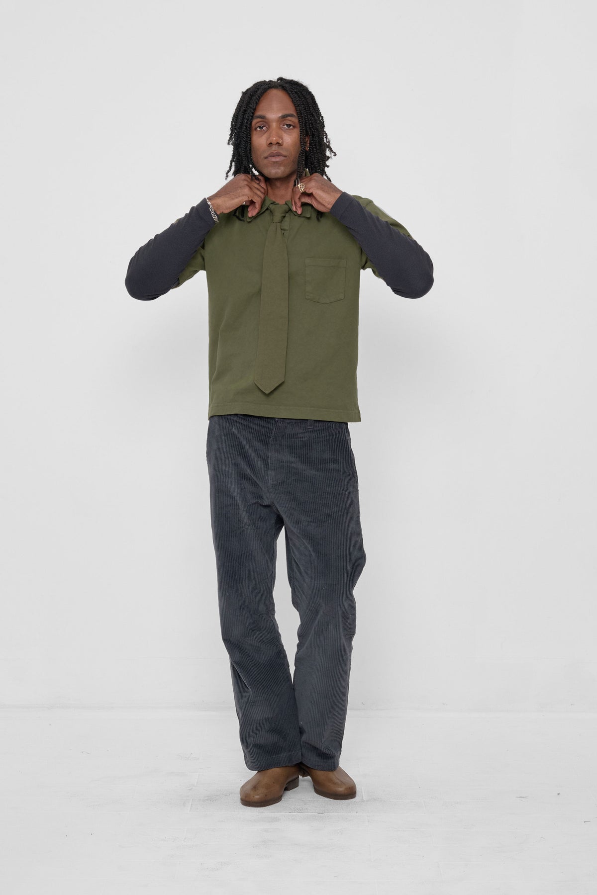 Trash Tie in Olive – on a model, styled with a matching Trash Polo, a Slate Rib Long Sleeve and Slate Cord Pants
