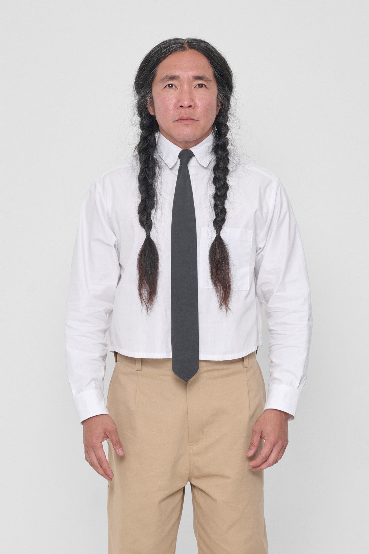 Person wearing Slate Trash Tie with White Peach Fuzz Cropped Button-Up Shirt.