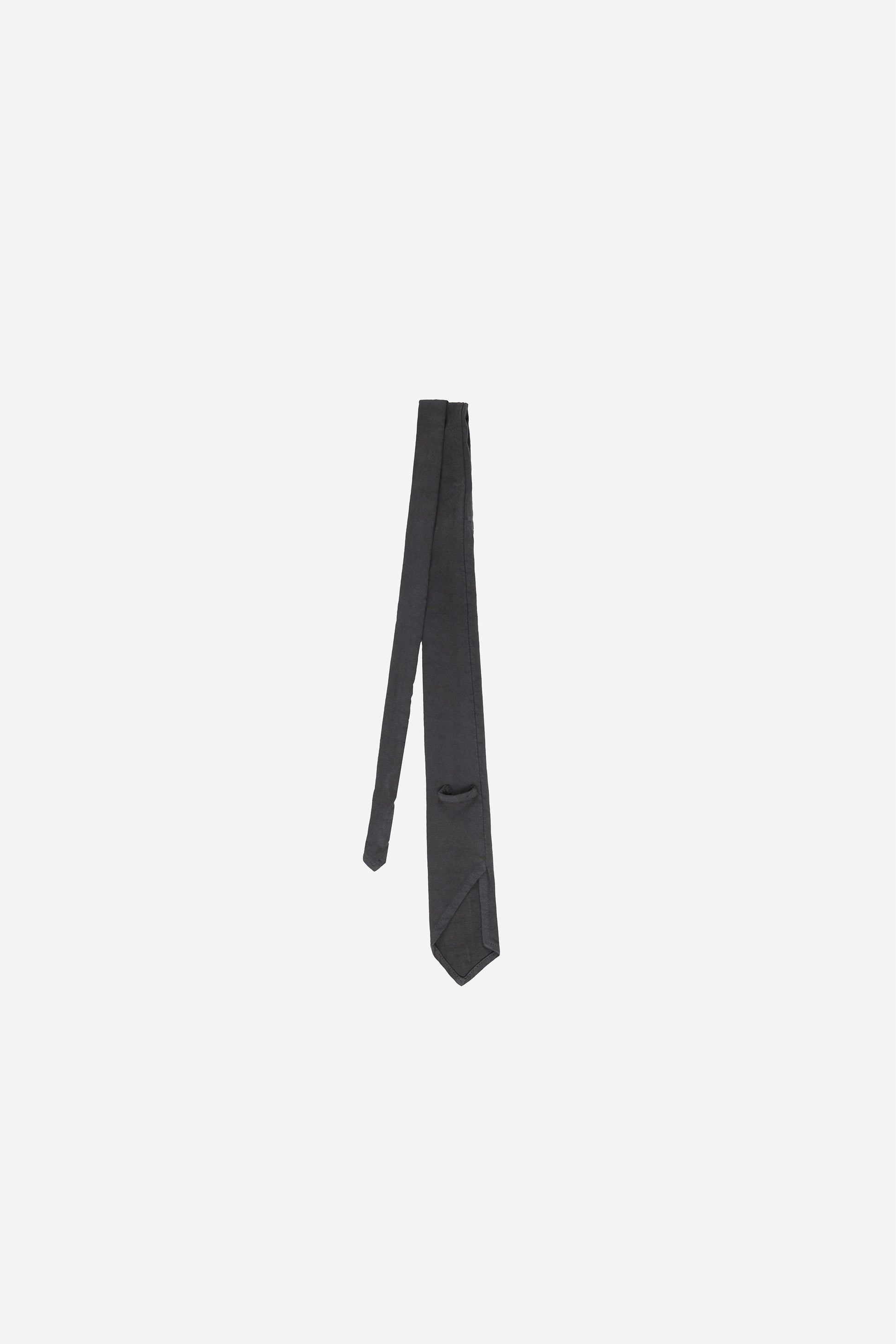 Back flat lay of Slate Trash Tie folded half way, showing loop and folded construction.