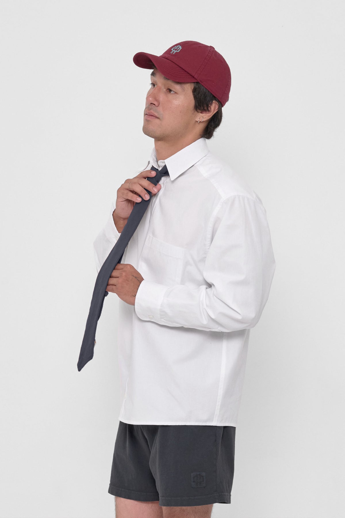 Trash Tie in Slate – on a model, tied around the collar of a White Peach Fuzz Button-Up Shirt