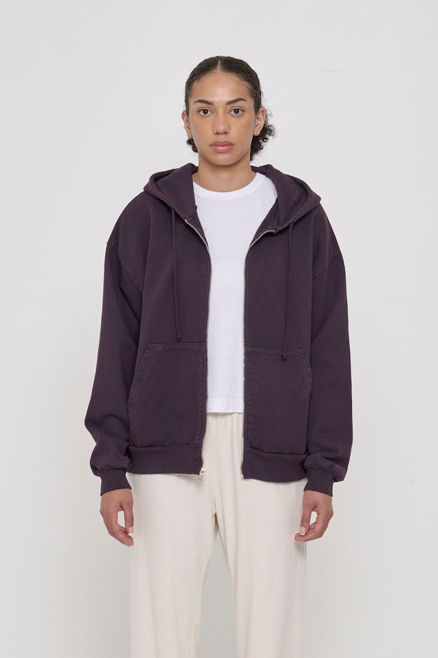 Front view of a person wearing Mulberry Trash Zip Up Hoodie. Hem hits mid hip.