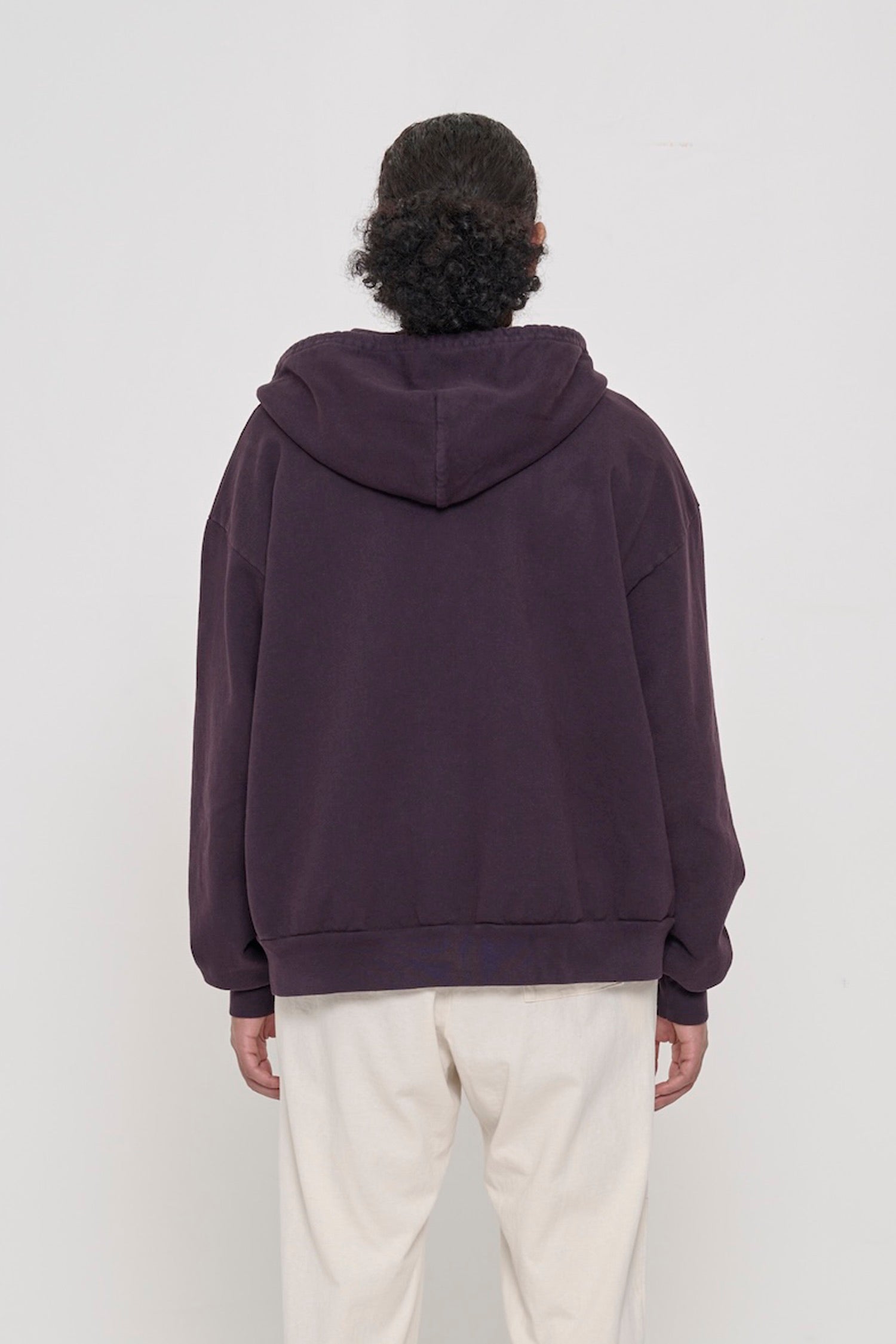 Back view of a person wearing a Mulberry Trash Zip Up Hoodie, highlighting the hood.