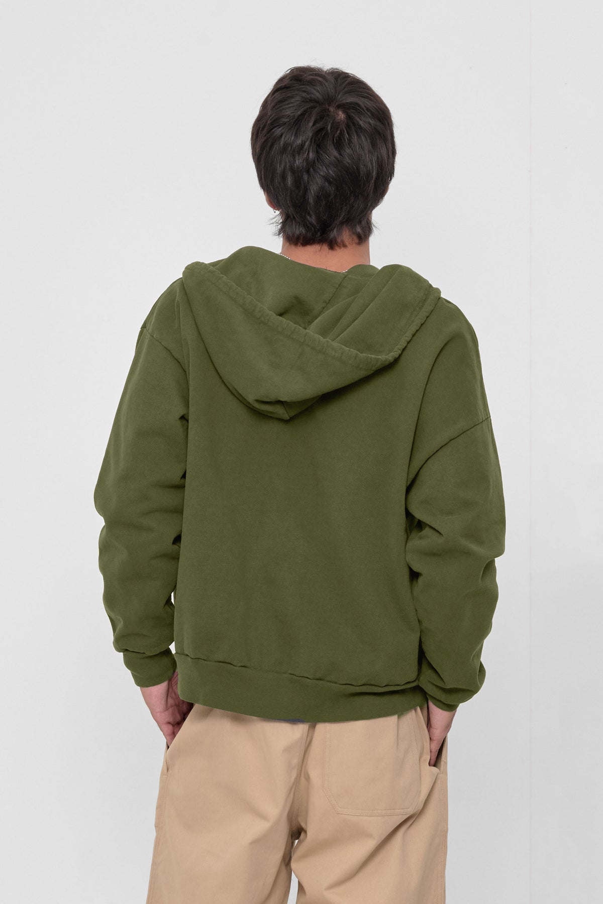 Trash Zip Up Hoodie in Olive – back view on model