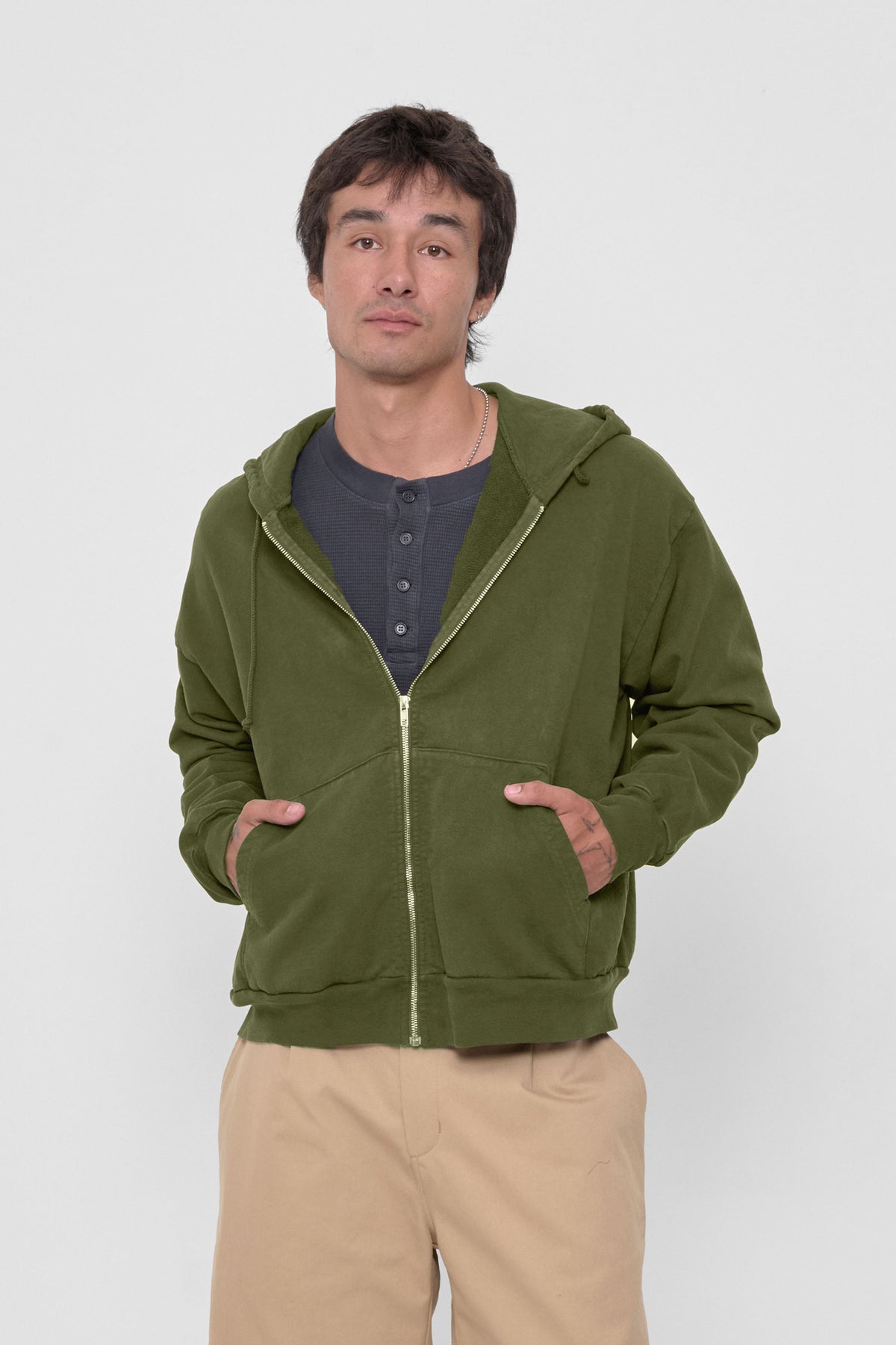 Trash Zip Up Hoodie in Olive – front view on model, unzipped over Slate Thermal Henley