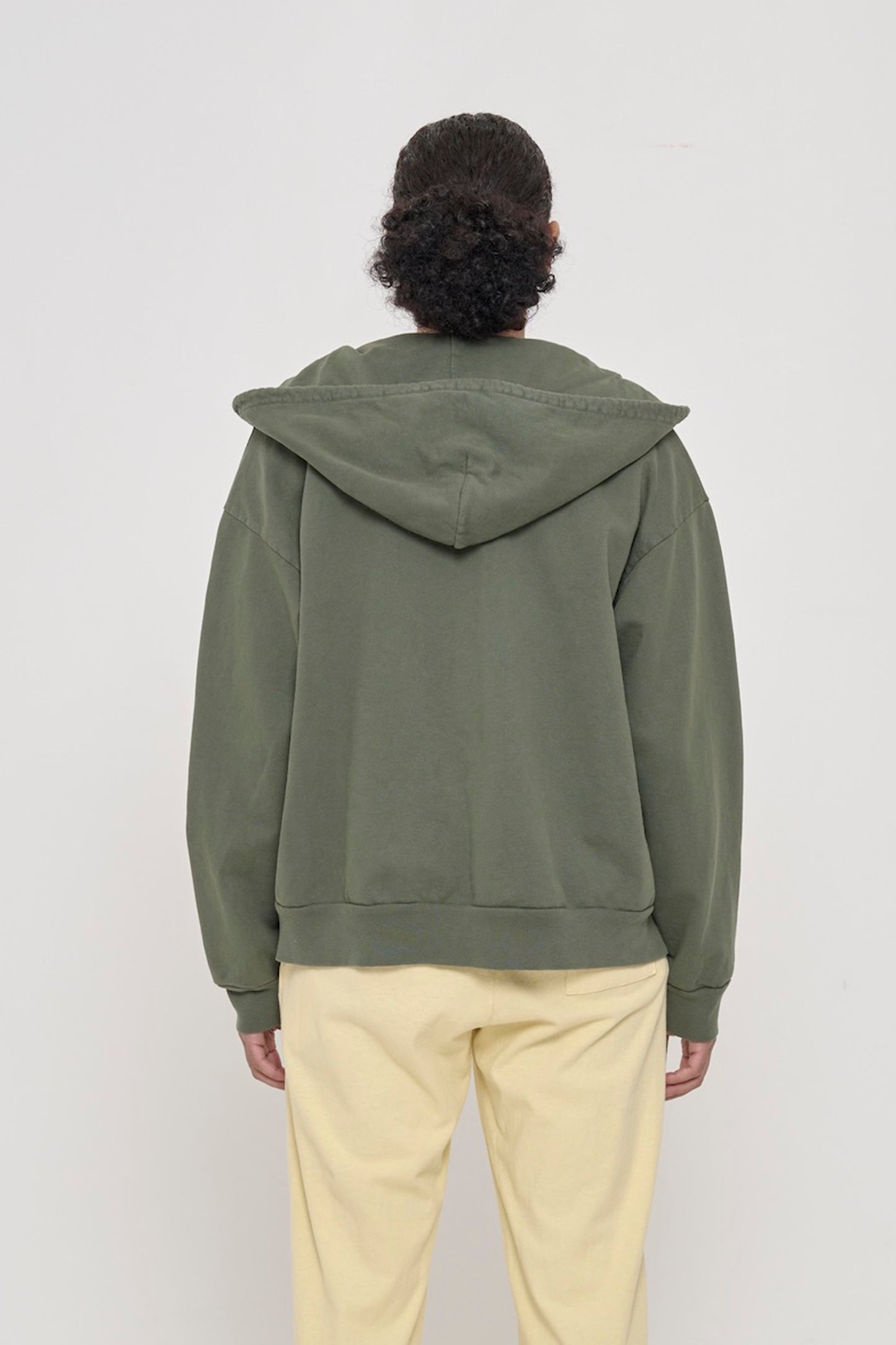 Back view of a person wearing a Pine Trash Zip Up Hoodie, highlighting the hood.