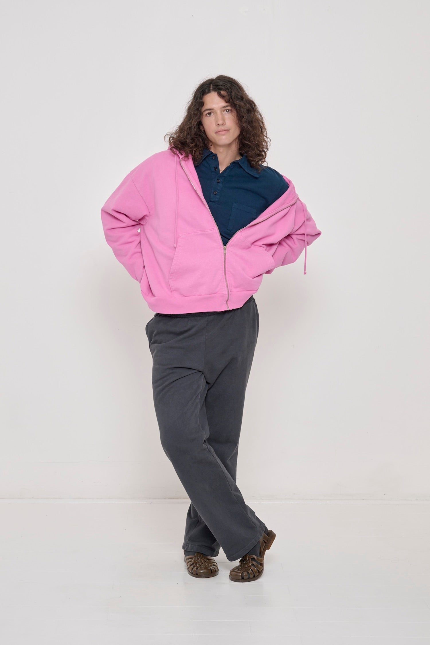 Person wearing half zipped Pixie Trash Zip Up Hoodie slouched off one shoulder with Juniper Rugby Trash Polo under. 