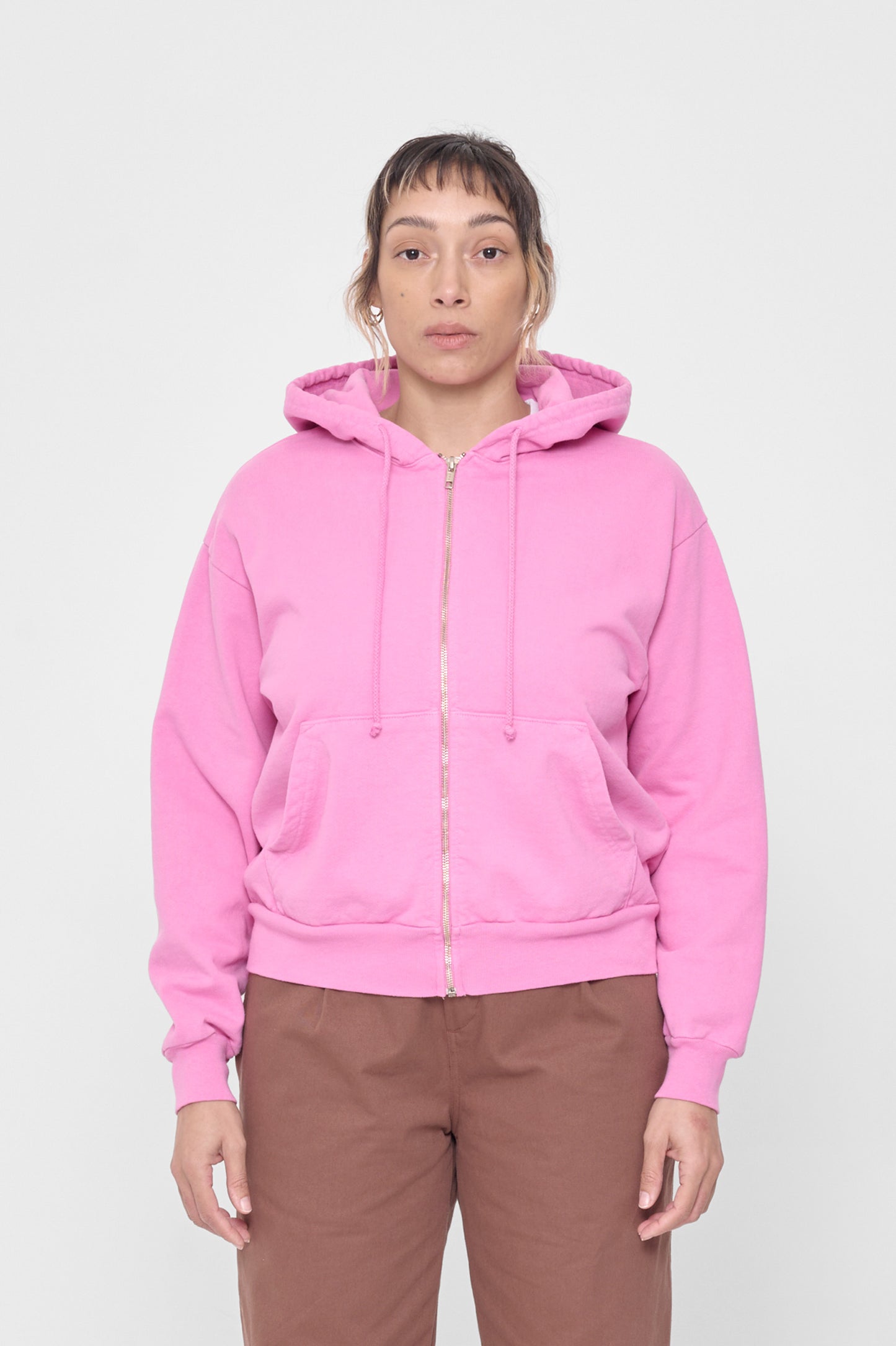 A 5'4" person wearing a size XS Pixie Trash Zip Up Hoodie. Hem hits mid hip.