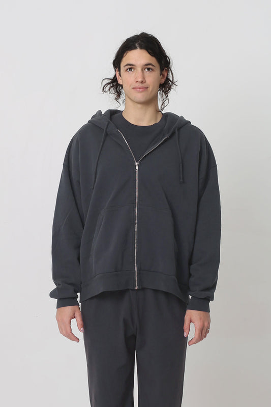 A 6' person in a size L Slate Trash Zip Up Hoodie. Hem hits their lower hip.