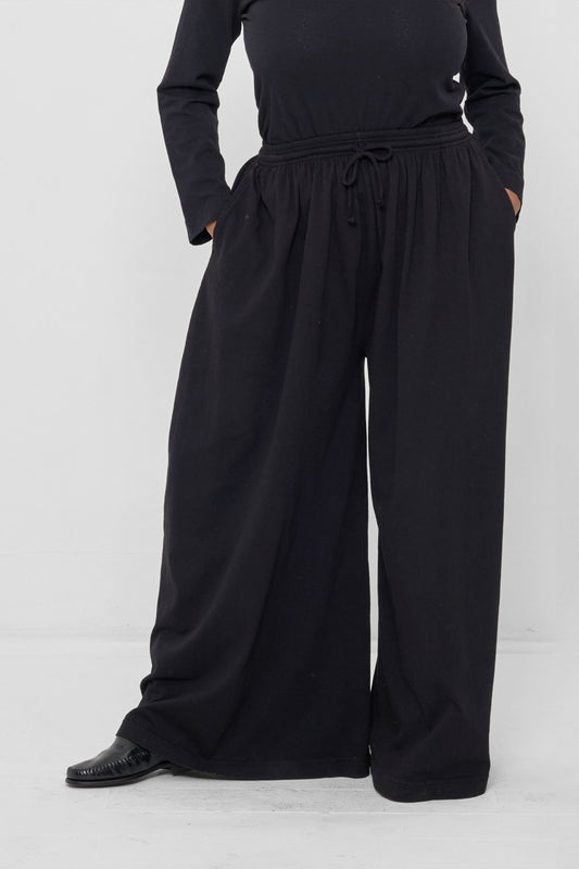 Tubular Pants in Black – front view on model