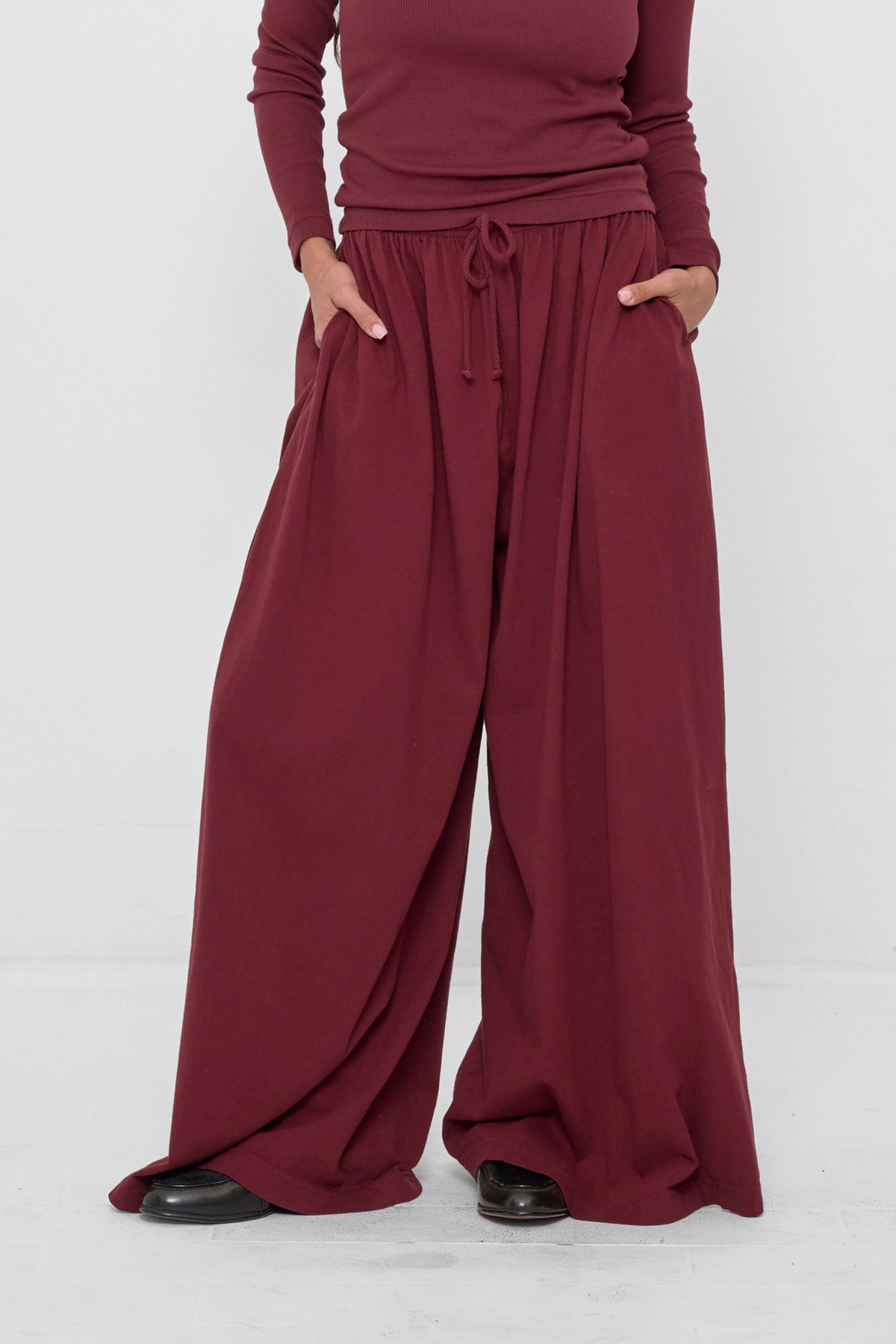 Tubular Pants in Garnet – front view on model